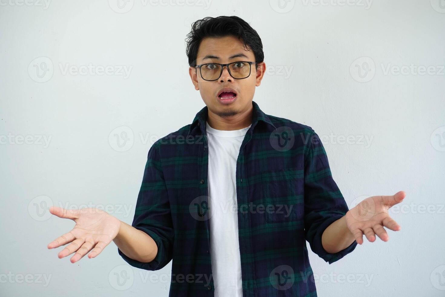 young asian man showing shocked face expression with open arms isolated on white background photo