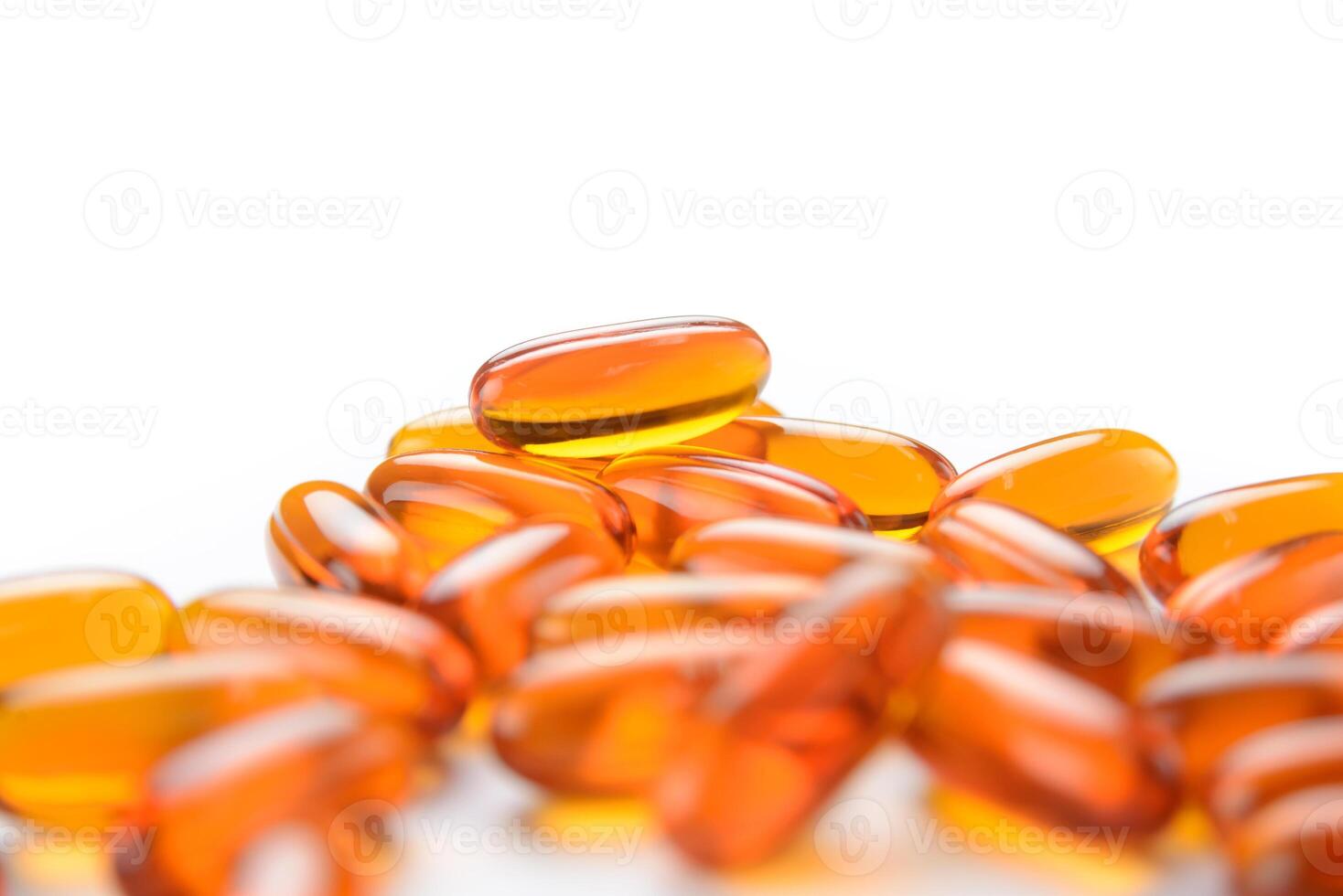 close up to pile of Fish oil capsules on a white background. soft gels capsules photo