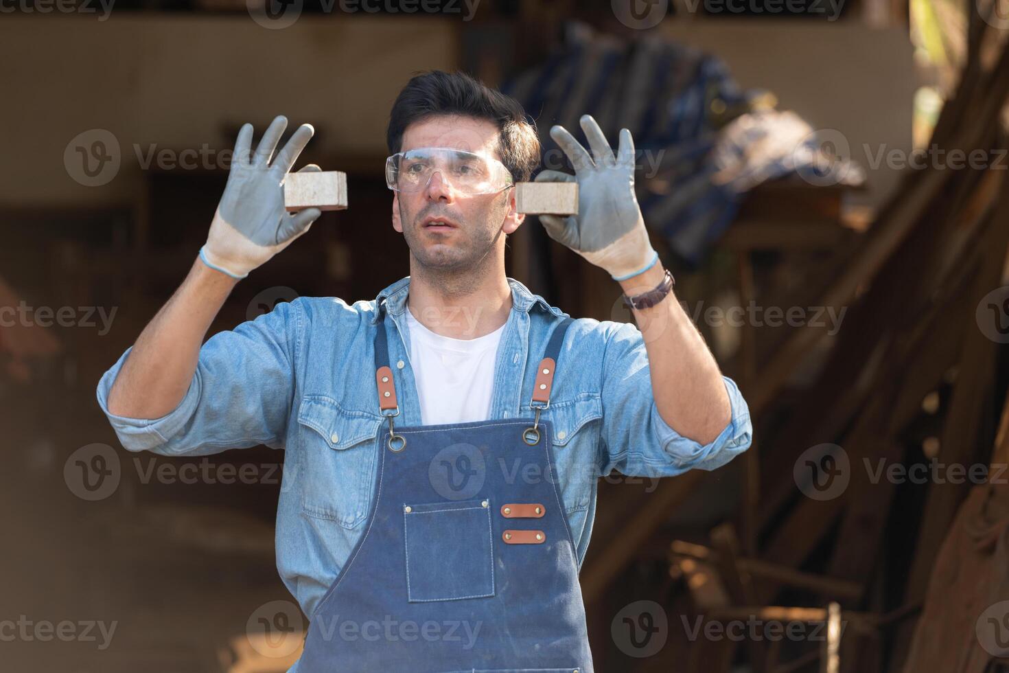 Carpenter working at his carpentry shop. Eyesight is utilized to ensure accuracy. photo