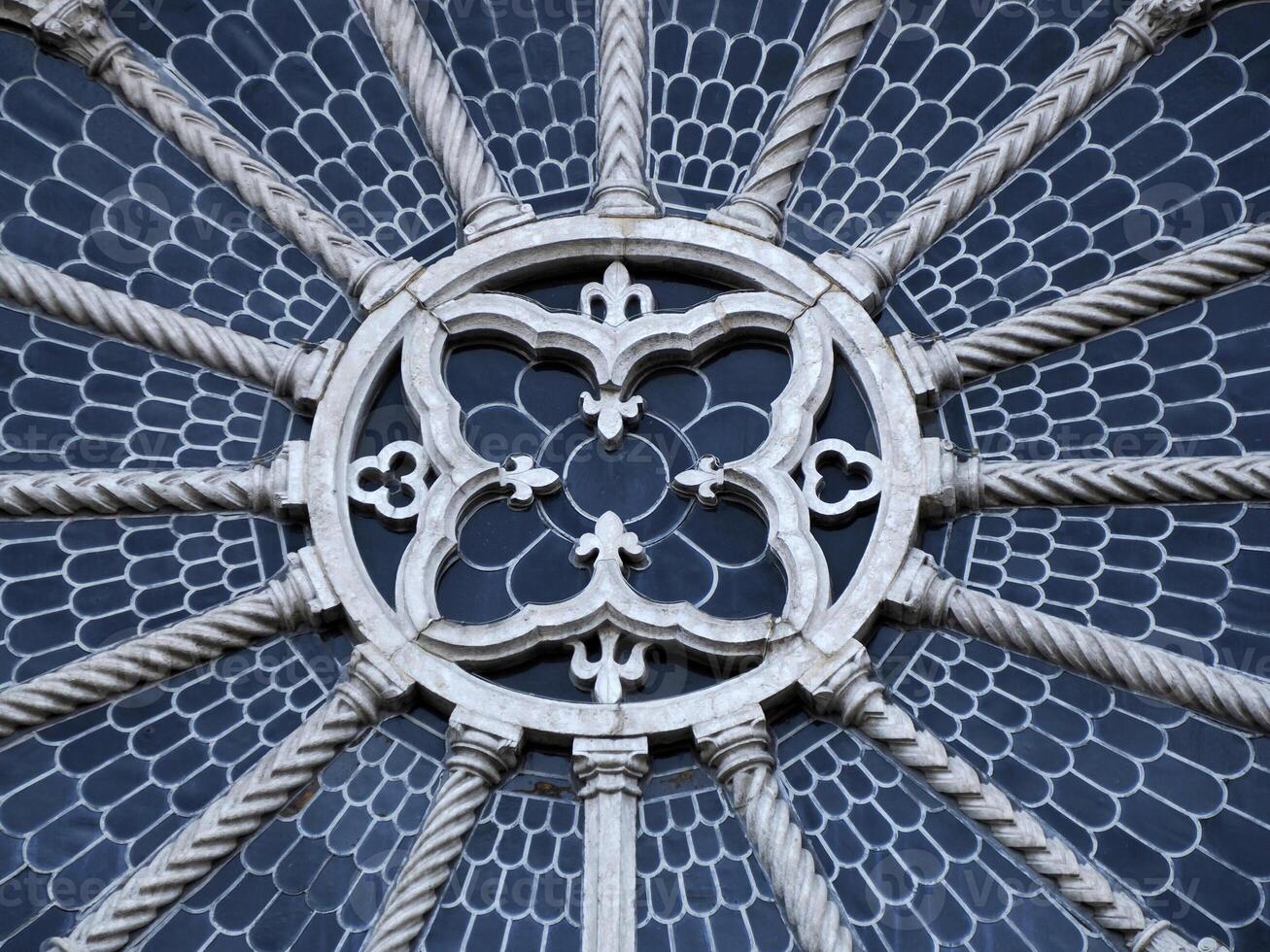 detail of the rose window of Medieval Cathedral of San Vigilio Dome Gothic style, Trento , Italy photo
