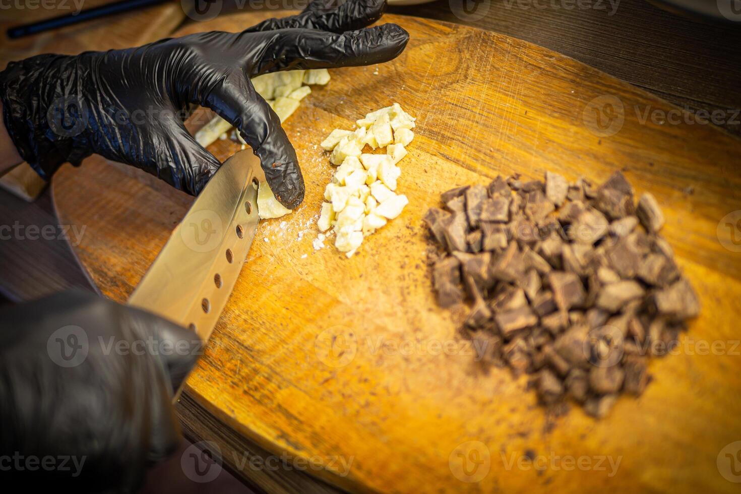 mujer Cocinando sabroso Derretido chocolate en mesa en cocina. foto