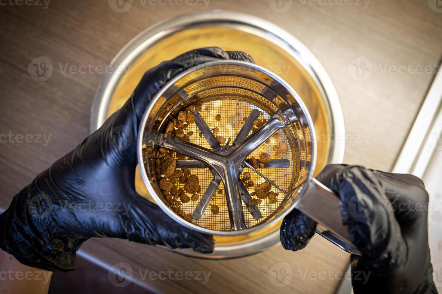 Woman cooking tasty melted chocolate on table in kitchen. photo