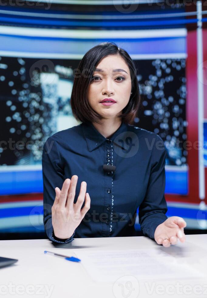 Journalist on late night show hosting entertainment and media segment using headlines to present breaking news. Woman presenter discussing about international reportage with exclusive details. photo