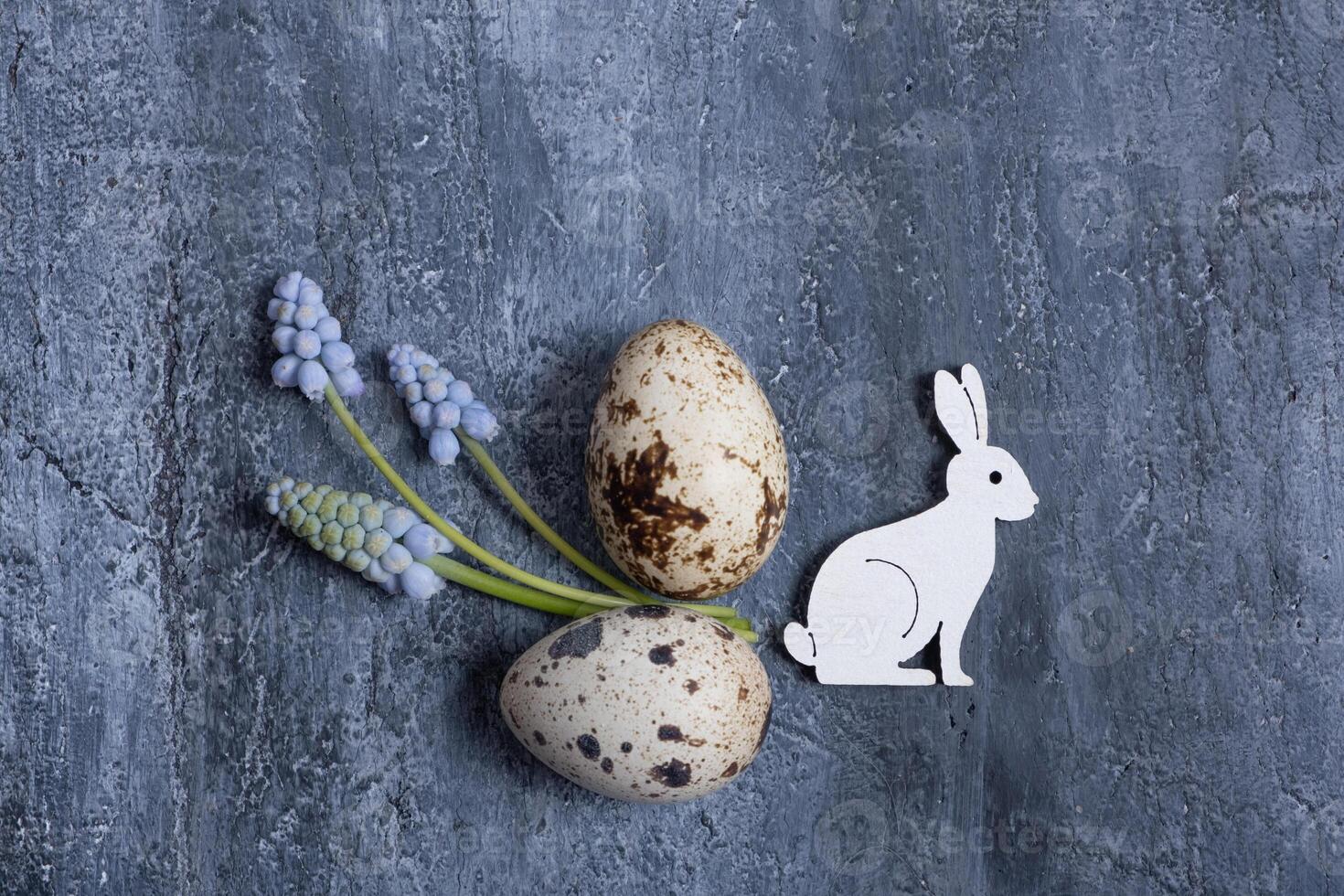 Easter composition with flowers, white rabbit and eggs  flat lay, top view. photo