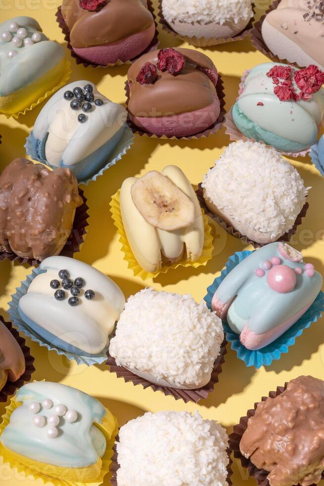 Set of different colourful macaroons on yellow background. Sweet food delicious. photo