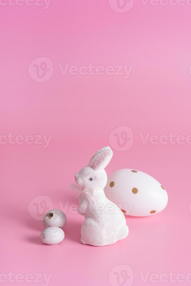 White rabbit and eggs symbol for Easter on a pink background background photo