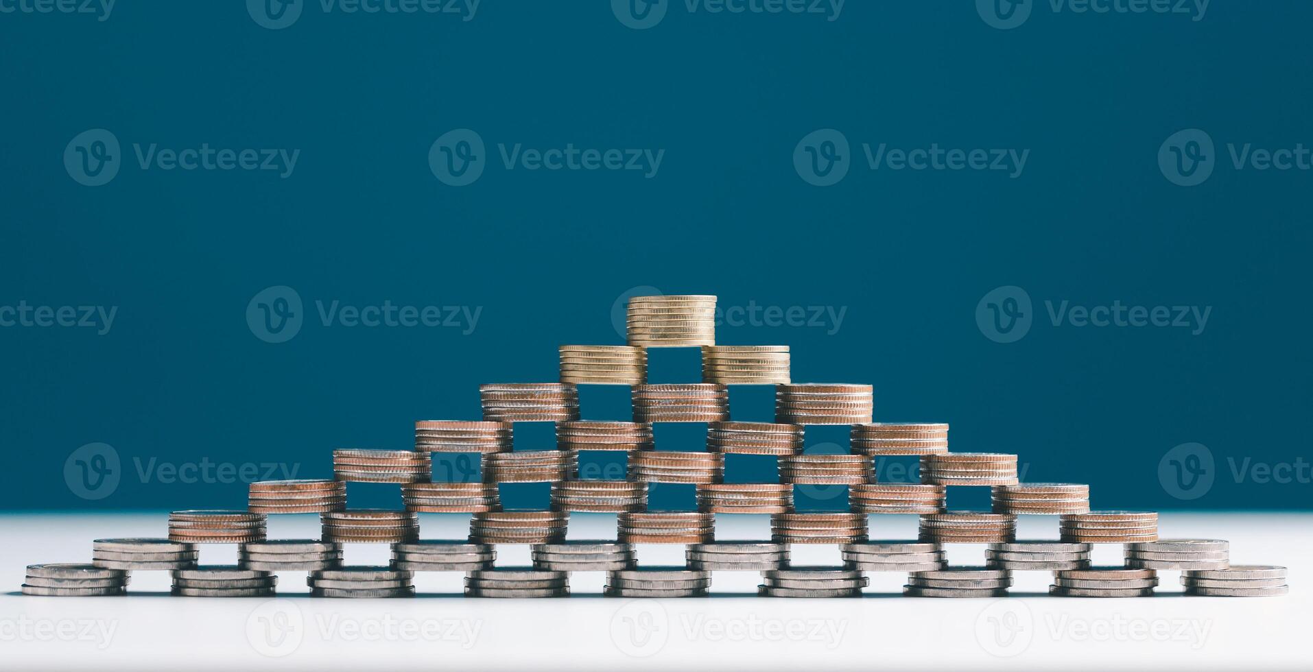 Coin stacks on a blue background. Coins stack for a financial business presentation background, home loan, money saving, stock and fund management, retirement plan concept, business growth, profit. photo