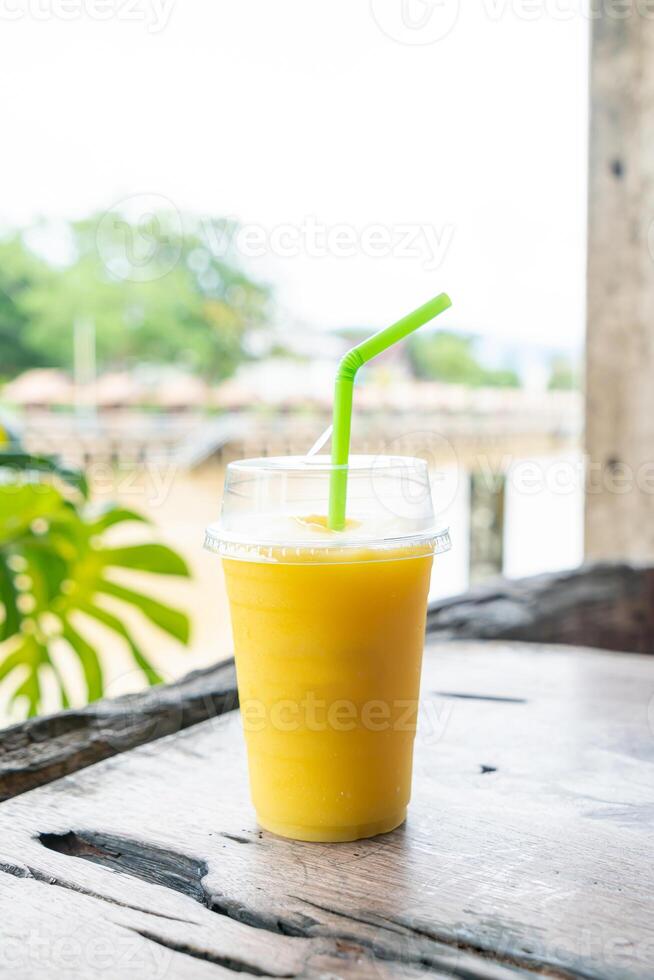 mango smoothies in take away glass photo