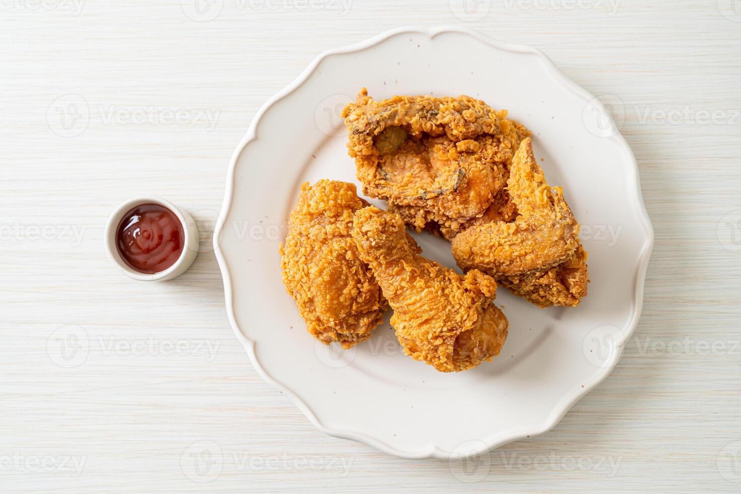 fried chicken with ketchup on plate photo