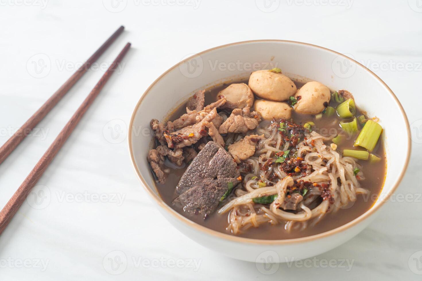 Thai noodle with pork, stewed pork, meatball and pork liver in blood soup photo
