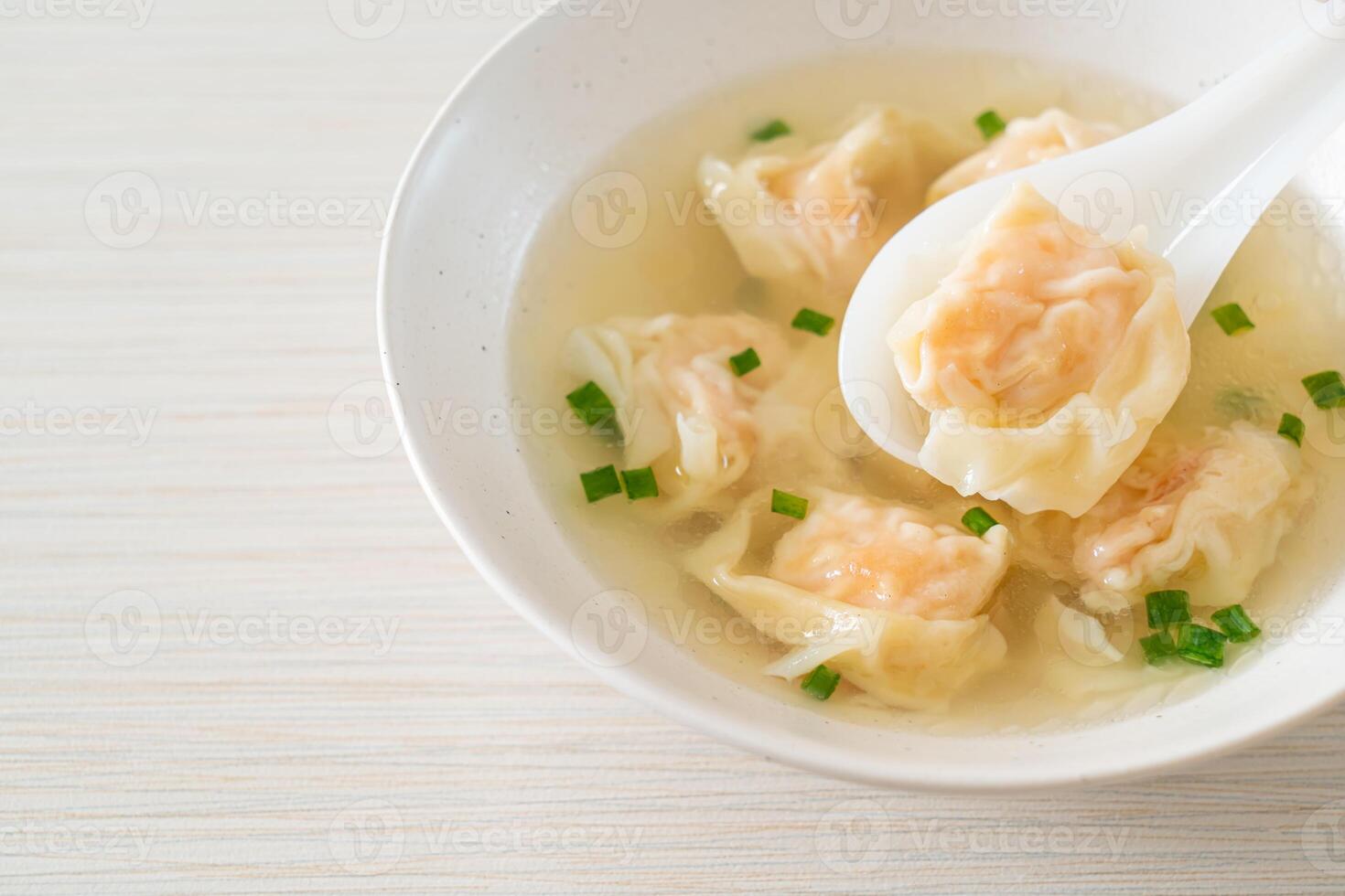 shrimp dumpling soup in white bowl photo