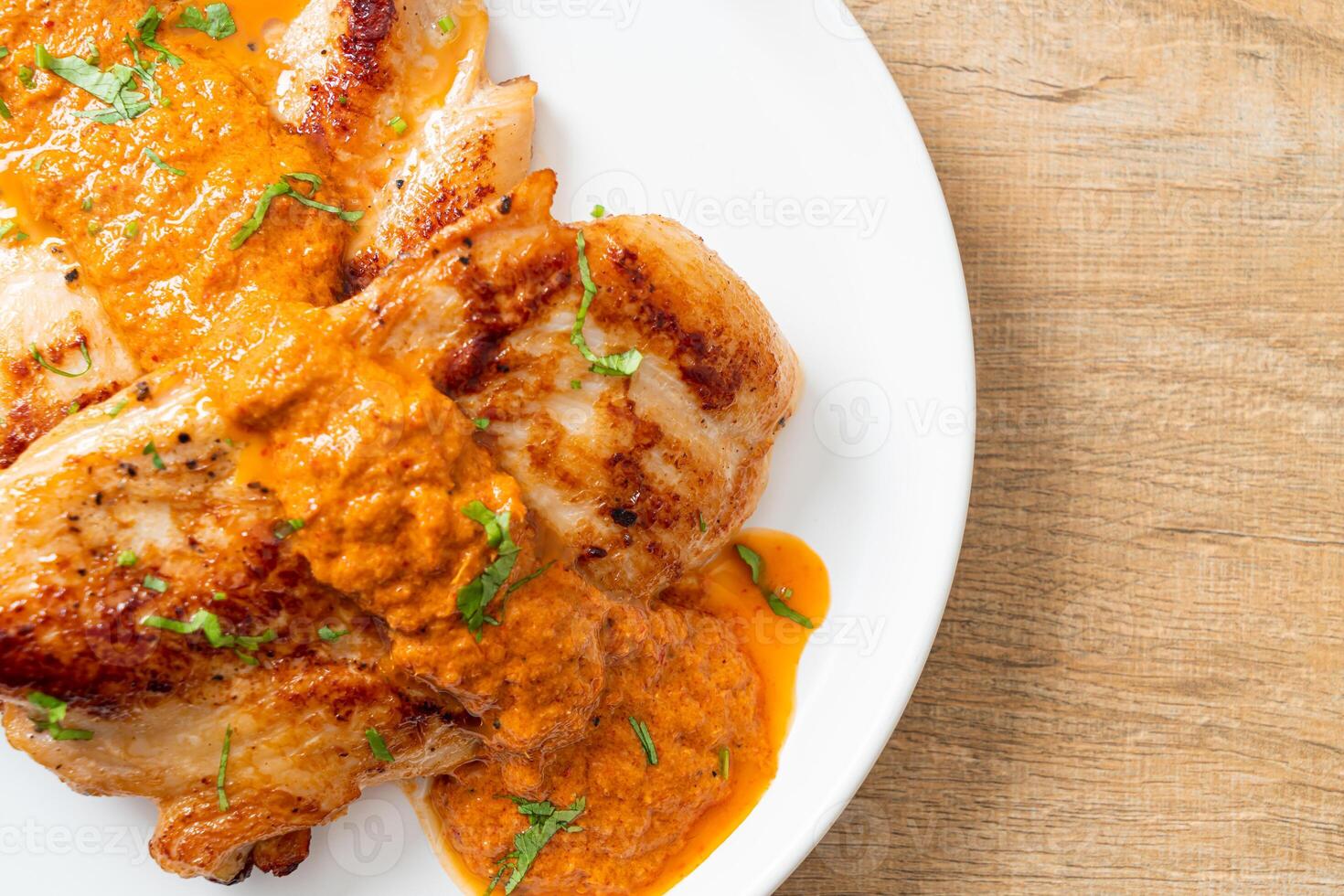 grilled chicken steak with red curry sauce photo