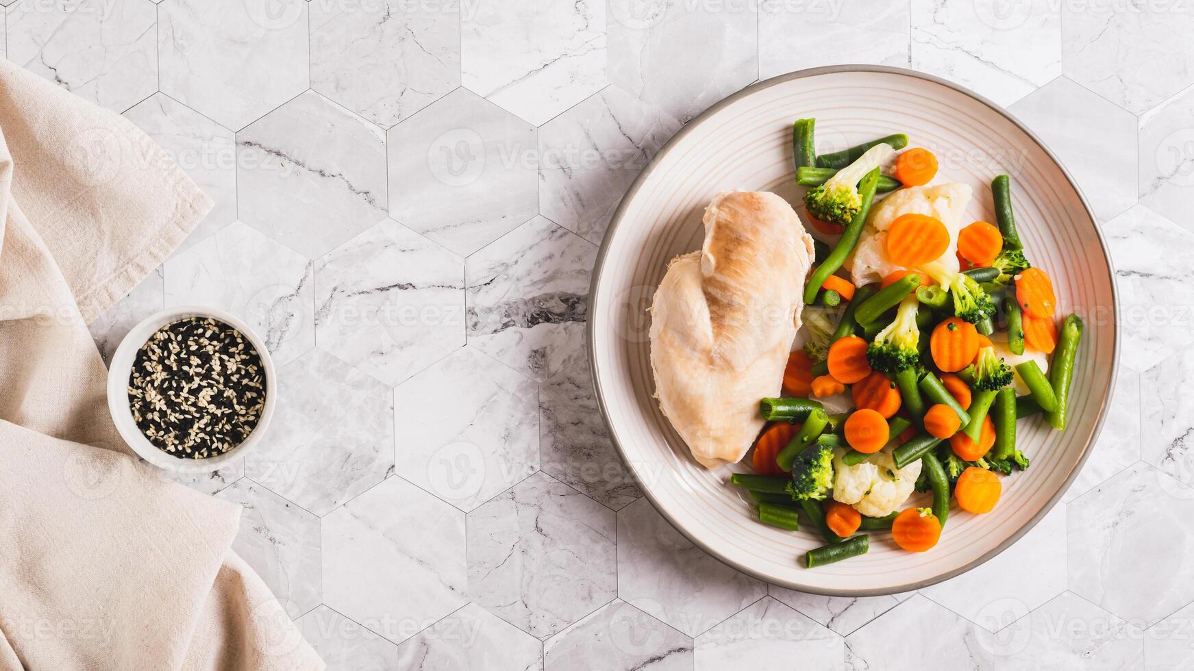 Boiled assorted vegetables and chicken fillet for diet food on a plate top view web banner photo
