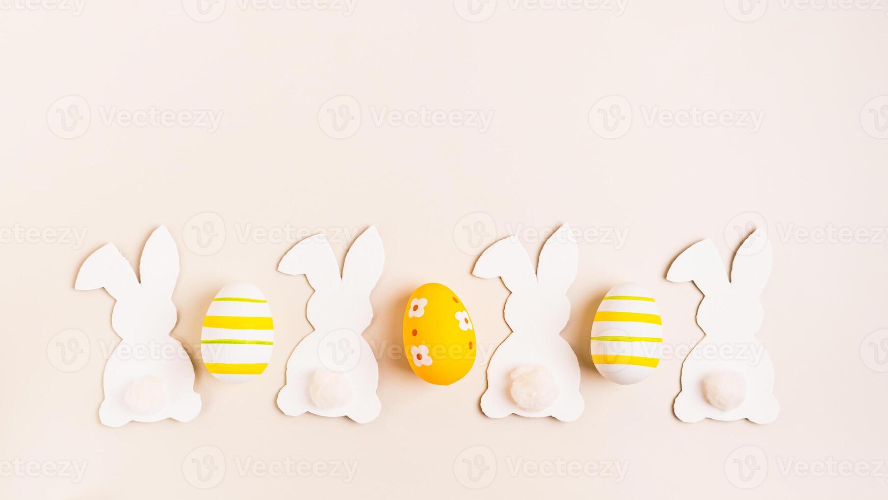 Happy Easter white decorative bunnies and easter eggs on pink background top view web banner photo