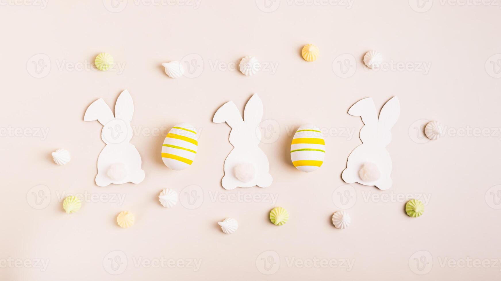 Happy Easter white bunnies, Easter eggs and mini meringues on pink background top view web banner photo