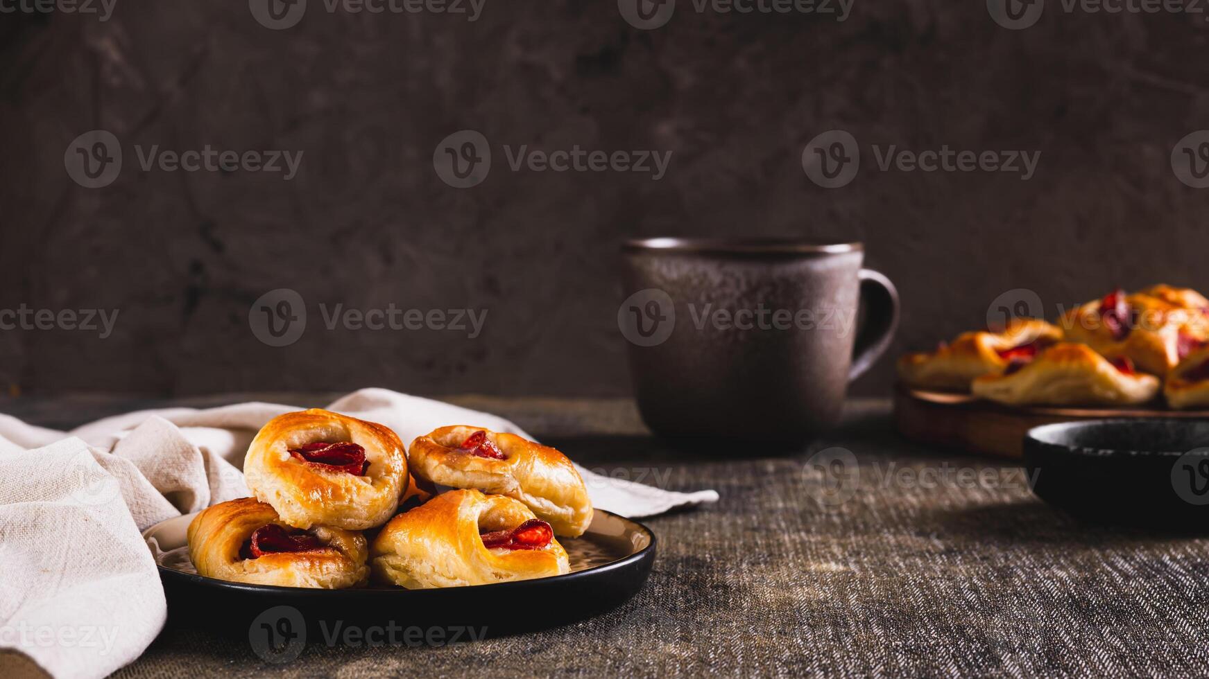 Appetizing envelopes with cheese and pepperoni sausage on a plate on the table web banner photo