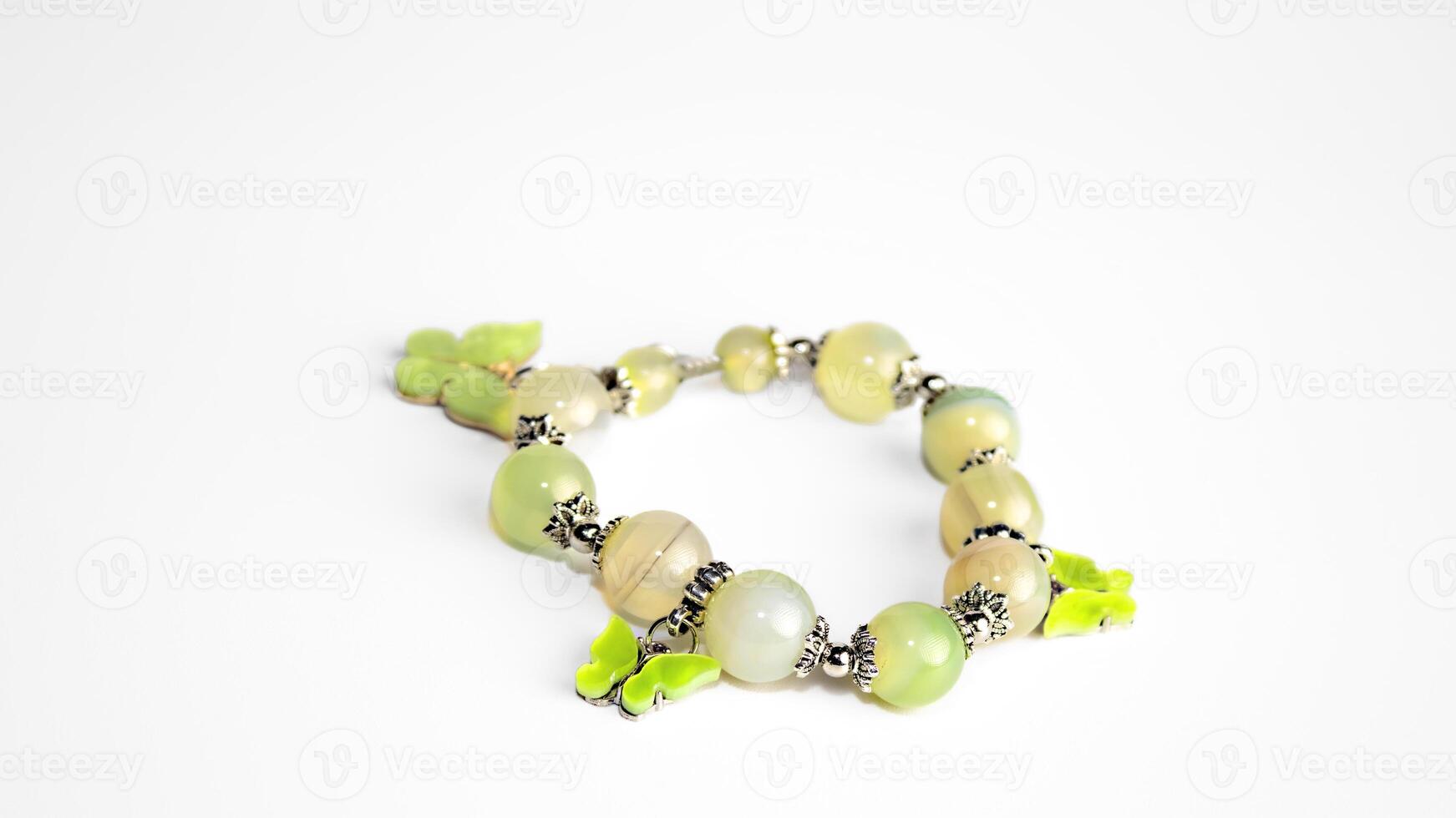 Beads from light green and yellow stones on a white background. High quality photo