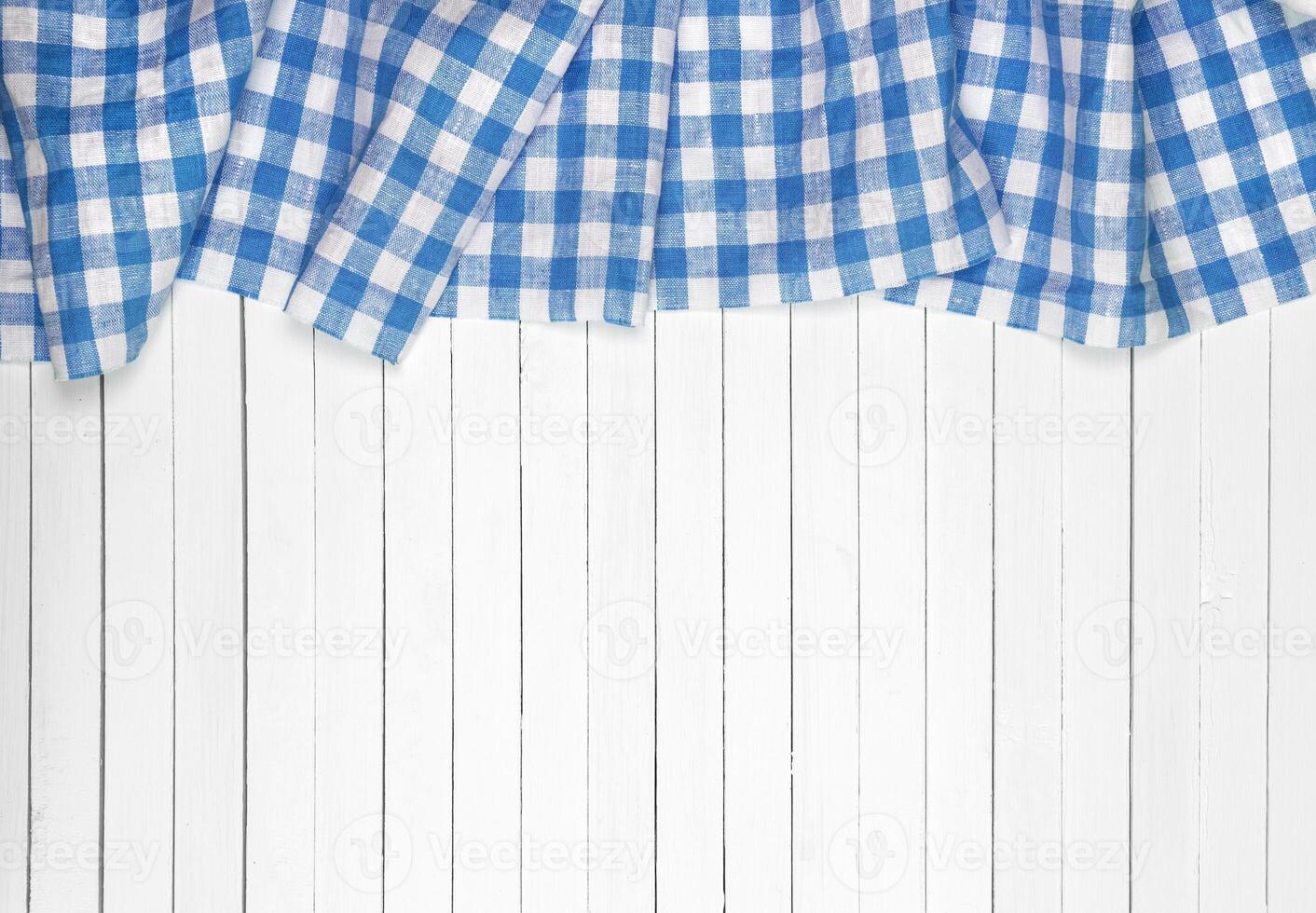 Blue tablecloth on wooden table, top view photo