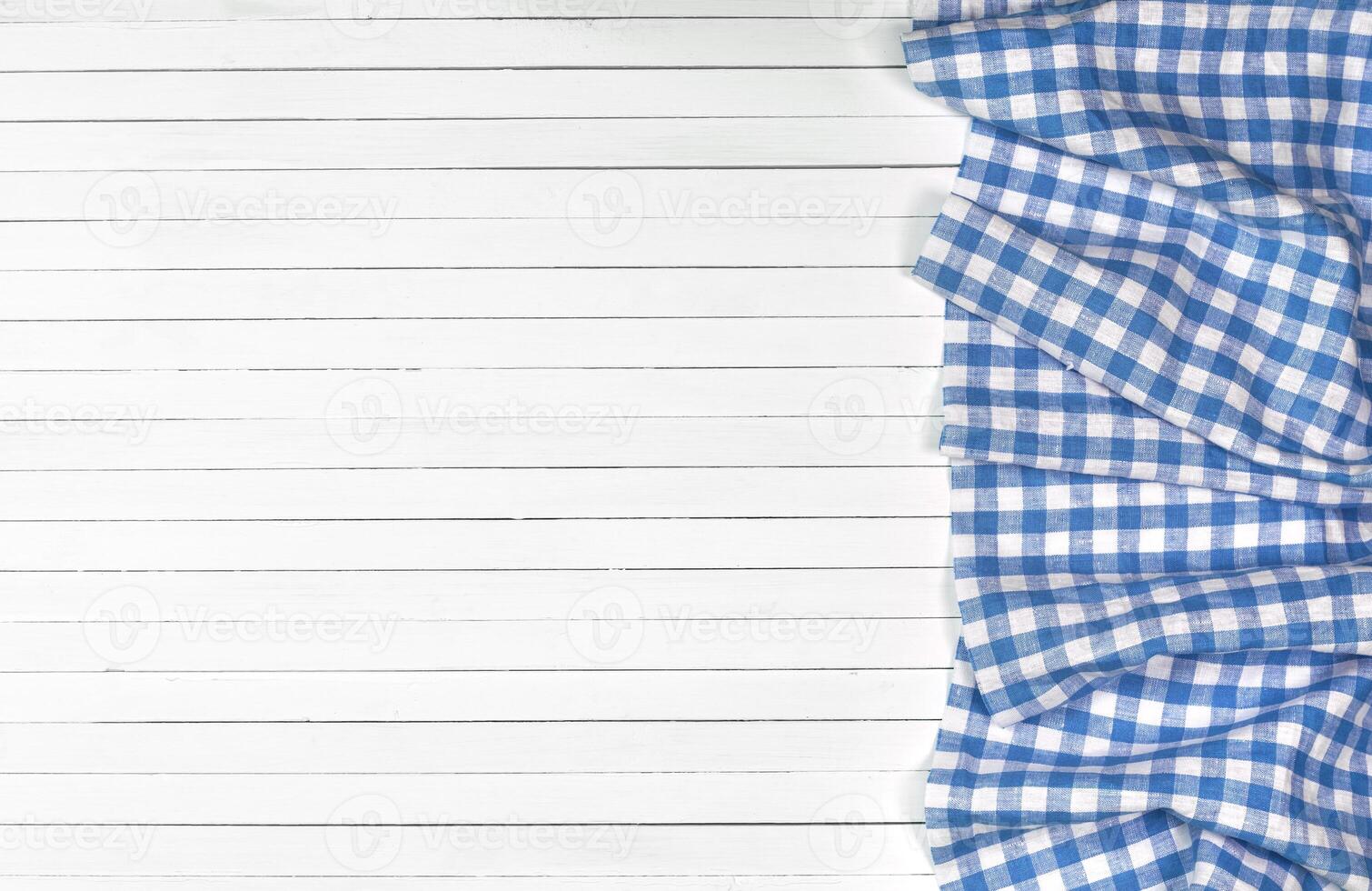 Blue tablecloth on wooden table, top view photo