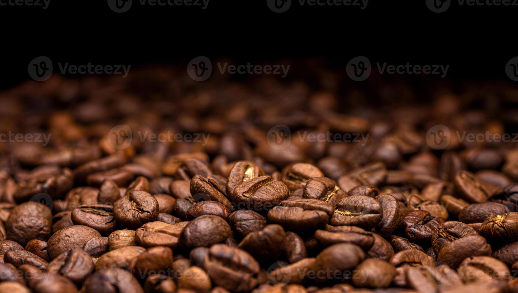 Coffee beans. Dark background with copy space, close-up photo