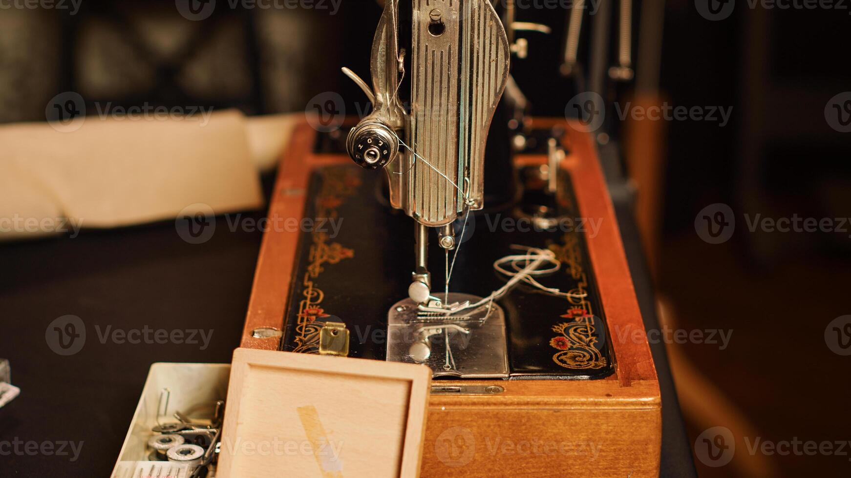 Tools on workstation in fashion atelier, needles and threads used for sewing and manufacturing clothes. Tailor workshop filled with textile industry equipment, craftsmanship. Close up. photo
