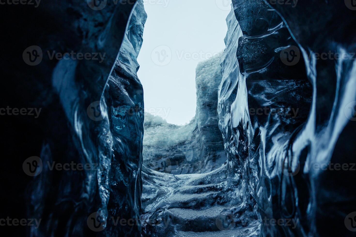 Big ice rocks inside glacier crevasse, transparent vatnajokull ice caves in icelandic landscapes. Spectacular frozen icebergs on wintry polar weather, melting icy blocks with cracked structure. photo