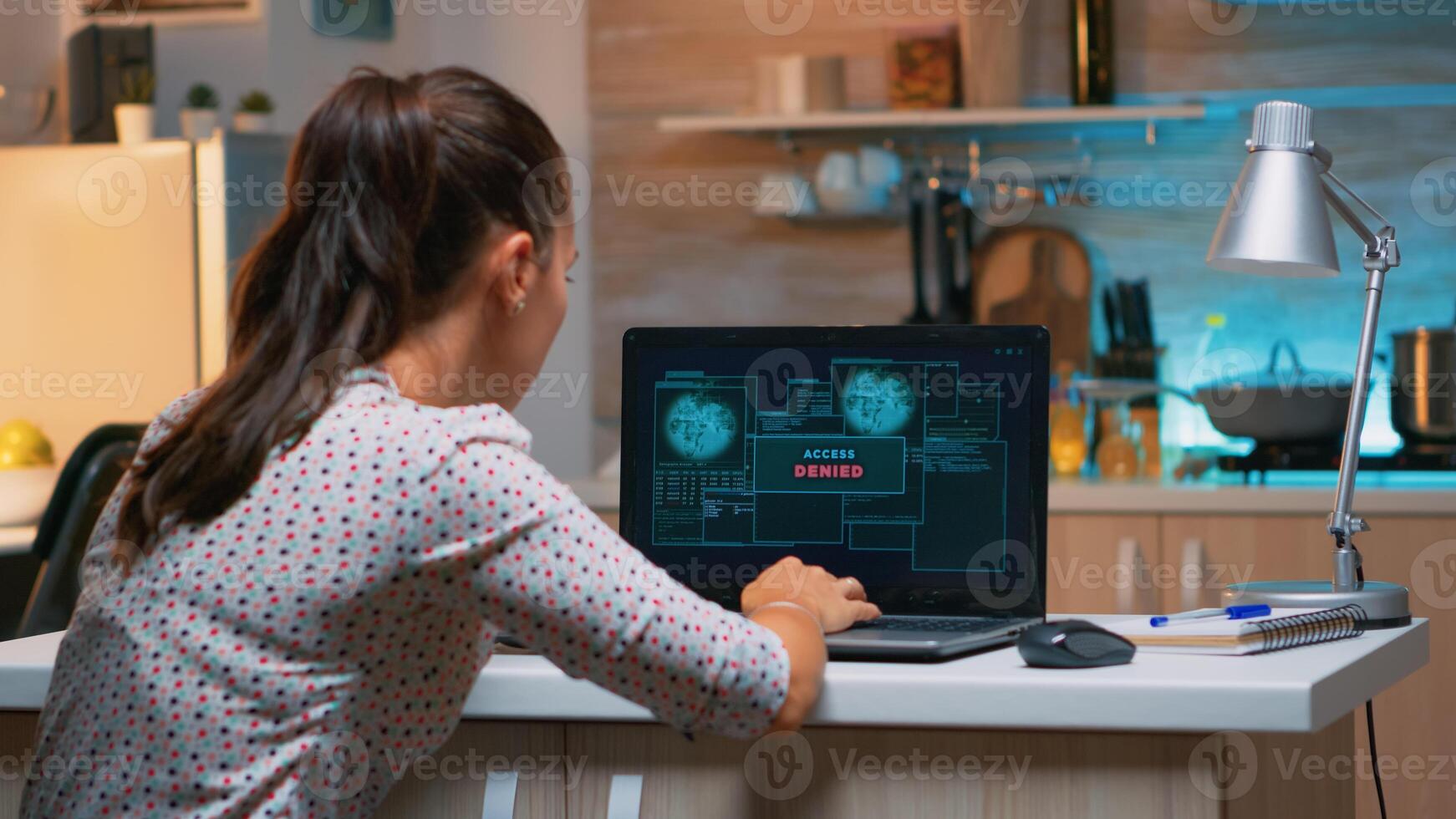 Angry female hacker of failing closing laptop working from home at computer. Programmer writing a dangerous malware for cyber attacks using performance pc during midnight. photo