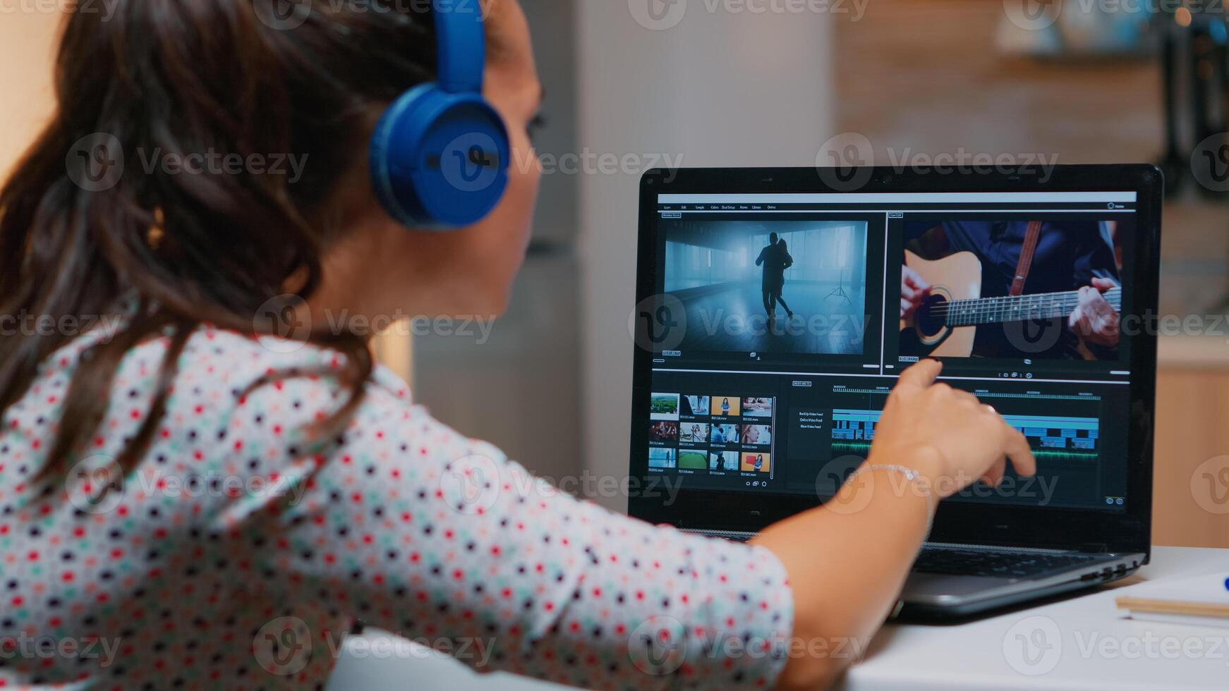 Videographer working on laptop from home, editing video and audio footage at night. Woman content creator using professional device modern technology network wireless processing film montage. photo