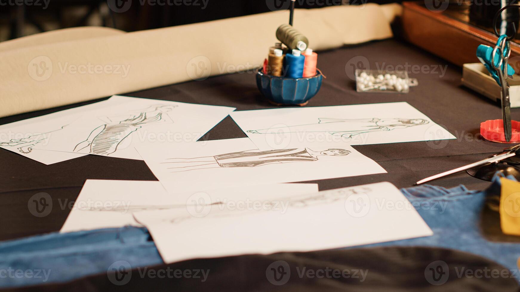 Empty atelier with clothes sketches on papers, modern clothing line and tailoring equipment. Industrial tools and sewing machine used in textile industry. Small business sewing shop. Close up. photo