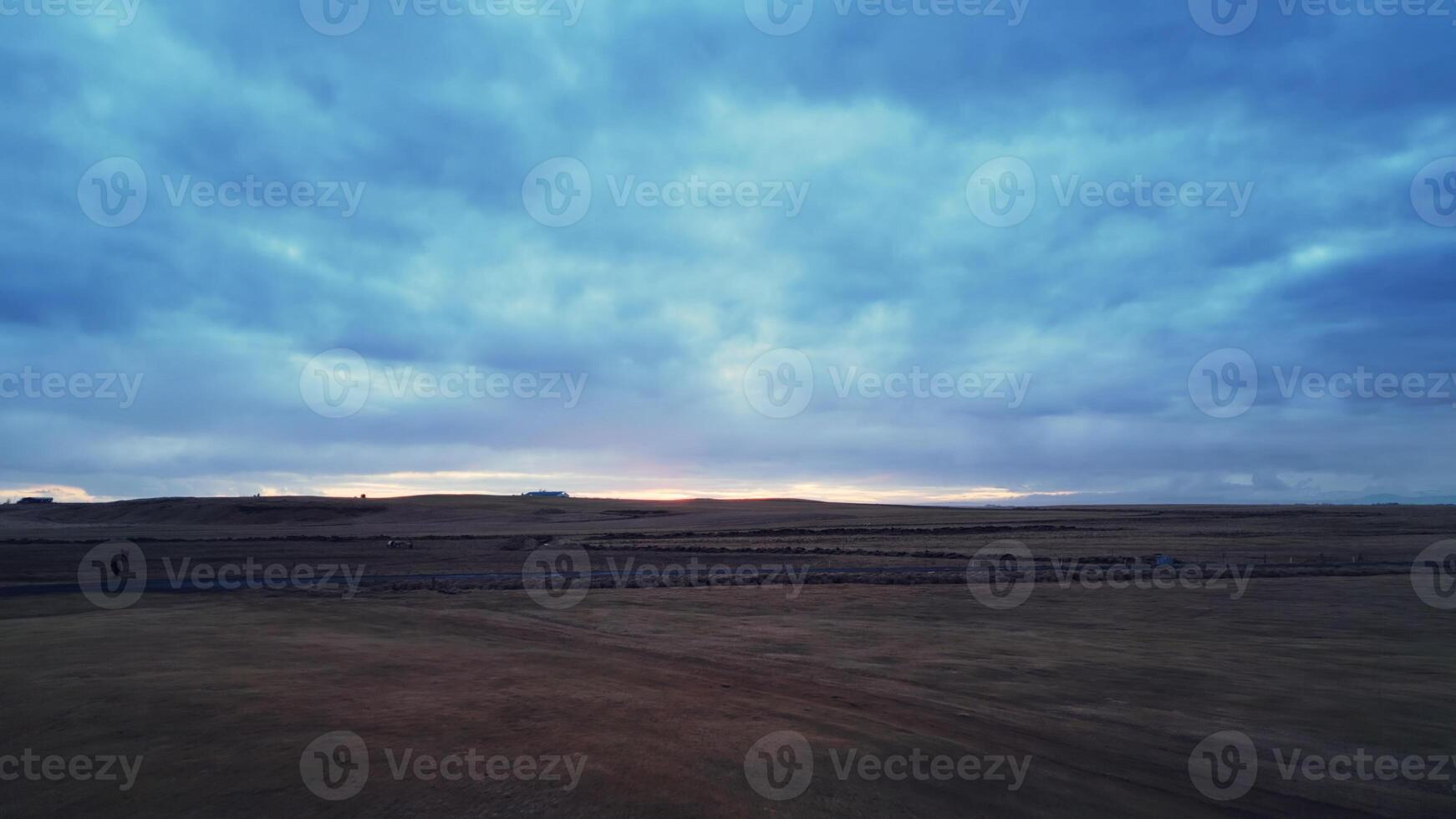 Large icelandic frozen fields in wintry weather, spectacular nordic landscape with snowy mountains and beautiful skies. Drone shot of candinavian scenery with nature, scenic route. photo