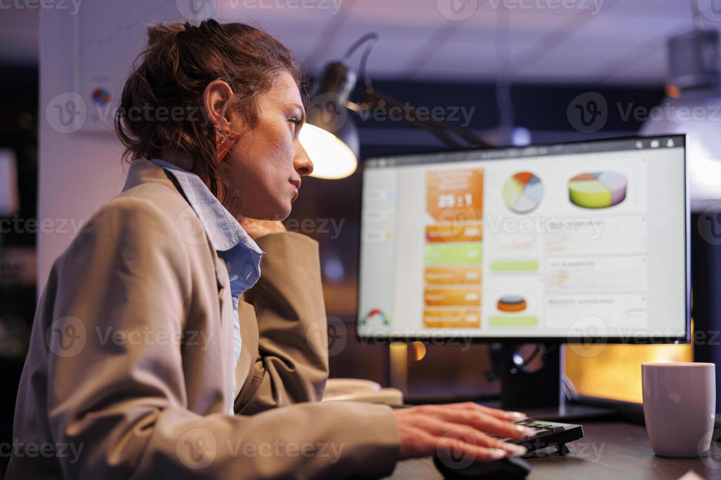 Entrepreneur planning financial investment report, typing company strategy using computer keyboard. Executive manager working late at night at marketing project in startup office. Business concept photo