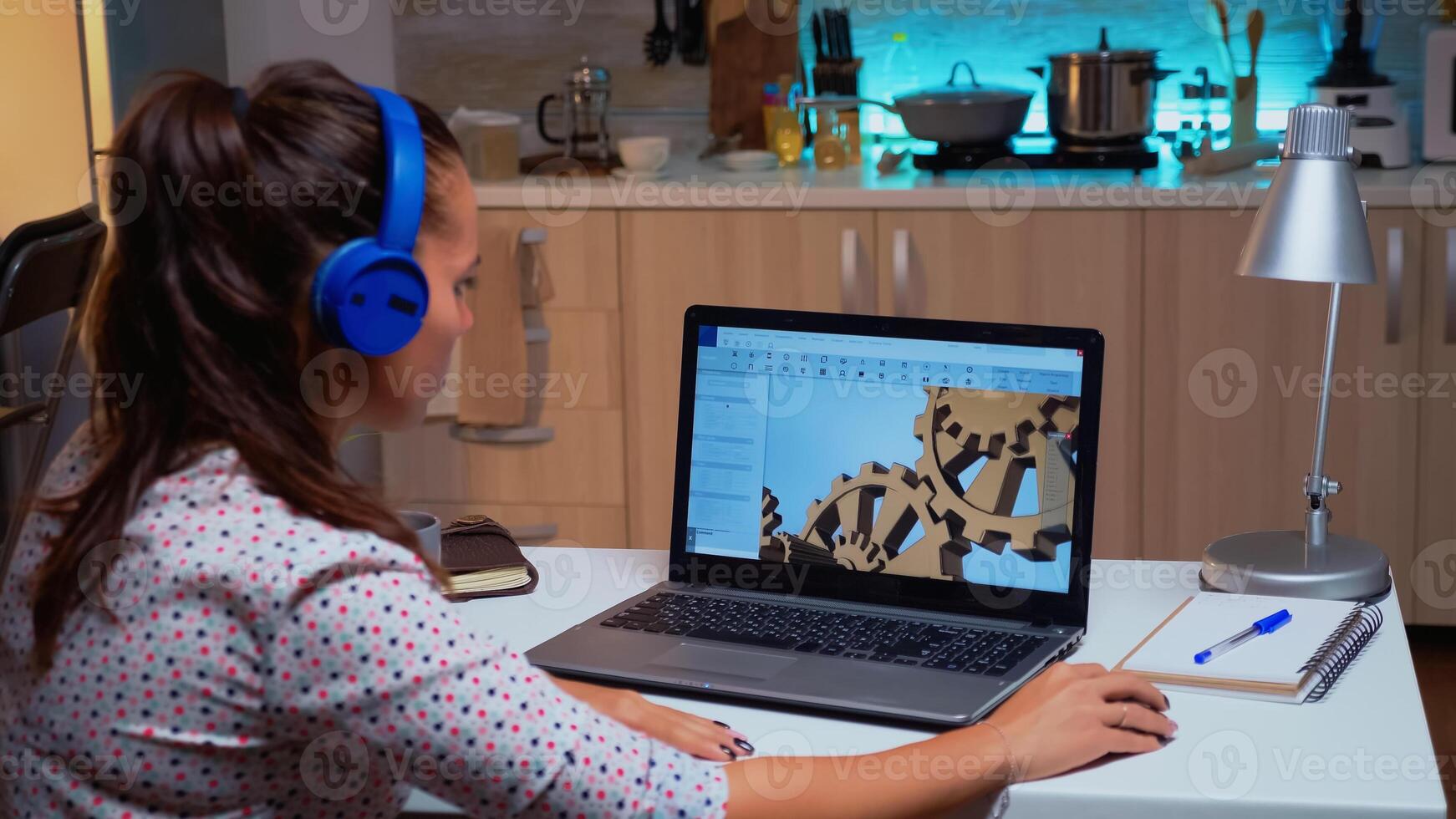 Design engineer working on a 3D component in CAD program on laptop from home. Industrial female employee studying prototype idea on personal computer showing cad software on device display photo