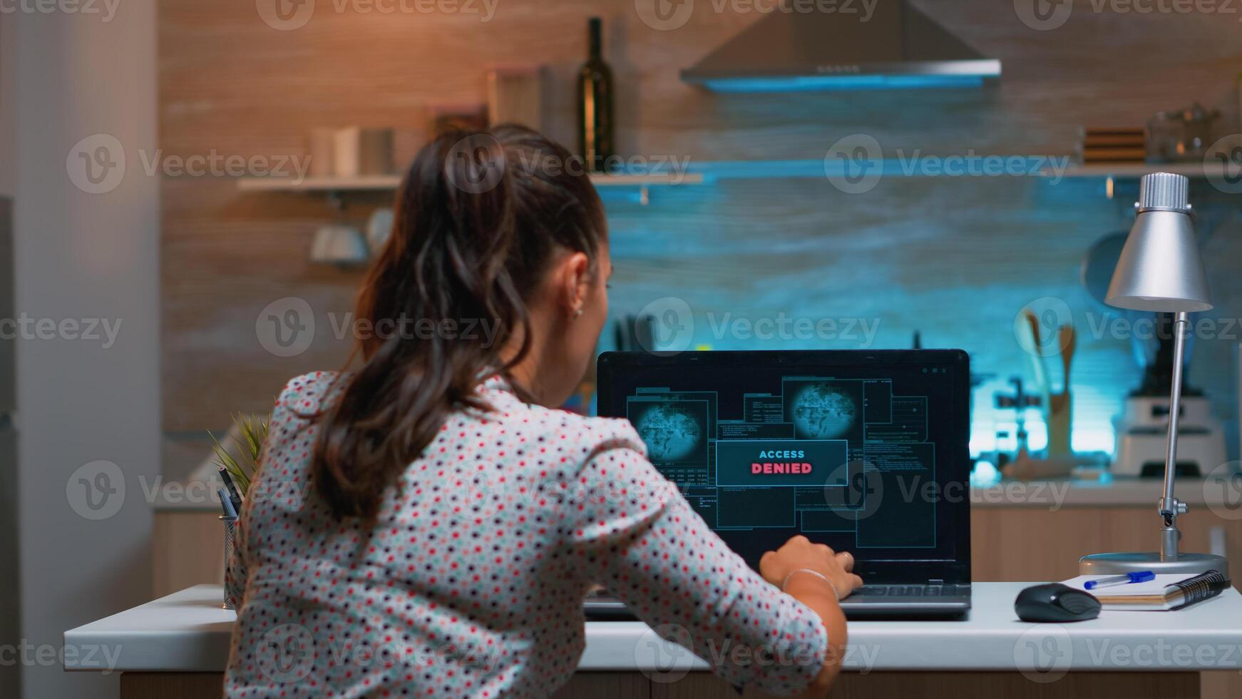 Hacker failing matching password and nervously closing laptop in midnight. Woman programmer writing a dangerous malware for cyber attacks using performance computer late at night. photo