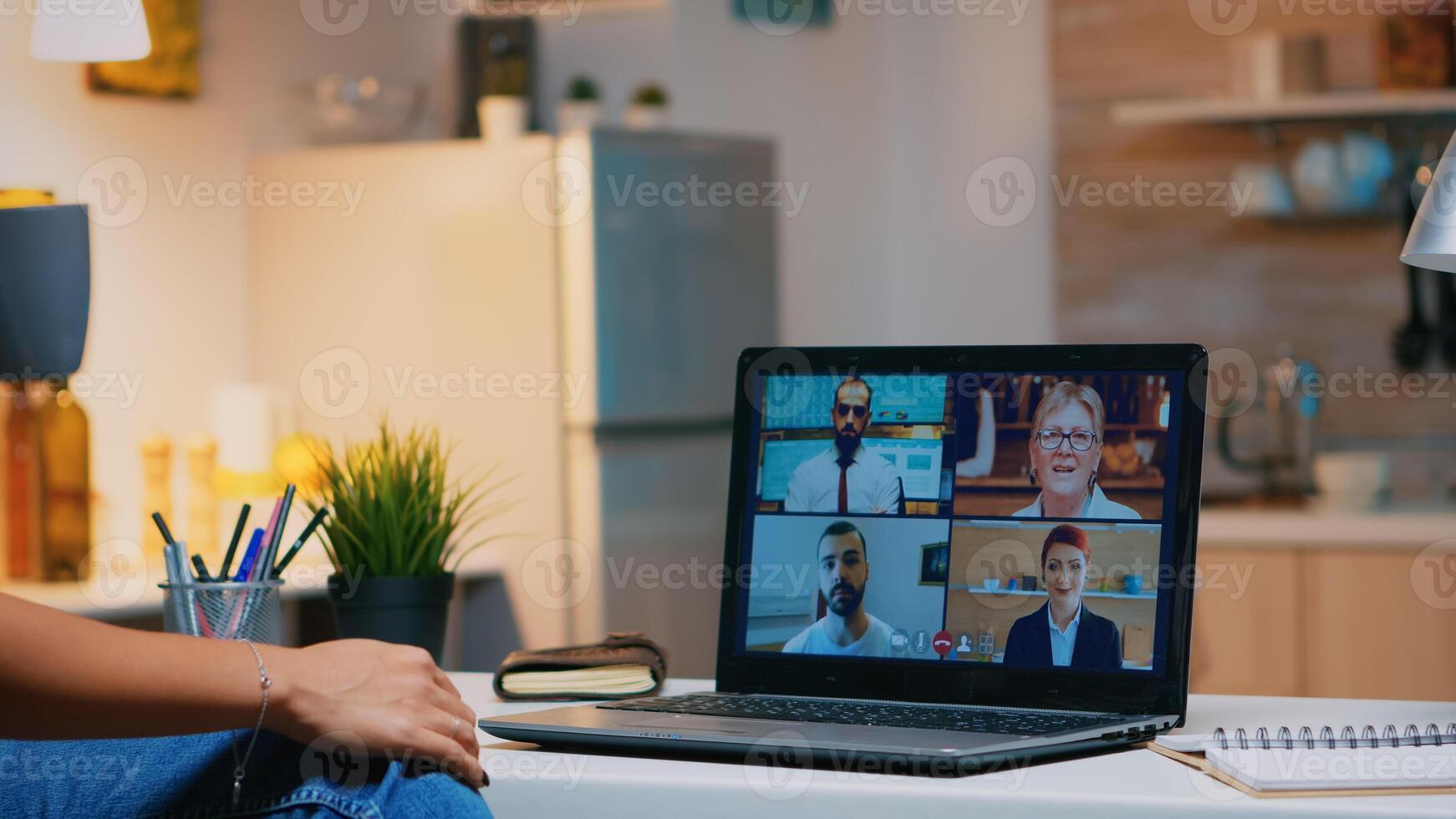 Business woman having webinar studying from home using internet technology on laptop in midnight. Lady using notebook with network wireless talking on virtual meeting at night doing overtime photo