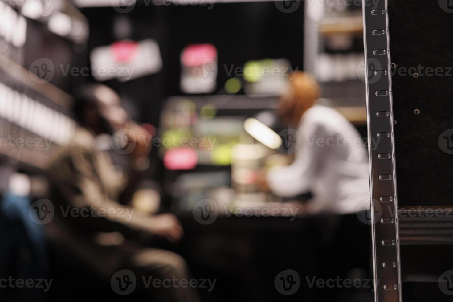 Blurred law enforcement professionals partners conducting investigation in private detective agency office. Two defocused man and woman investigators searching crime solving solution photo