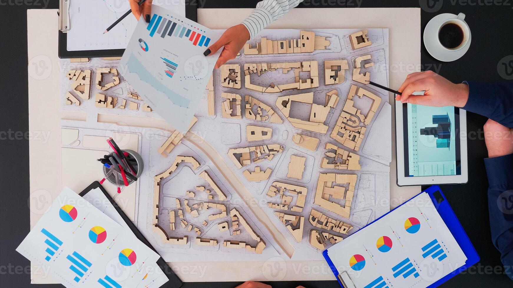 High angle view of architects with buildings prototype digital devices and tablet sitting at table in conferance office planning next project. Working on copy space, flat lay concept. photo