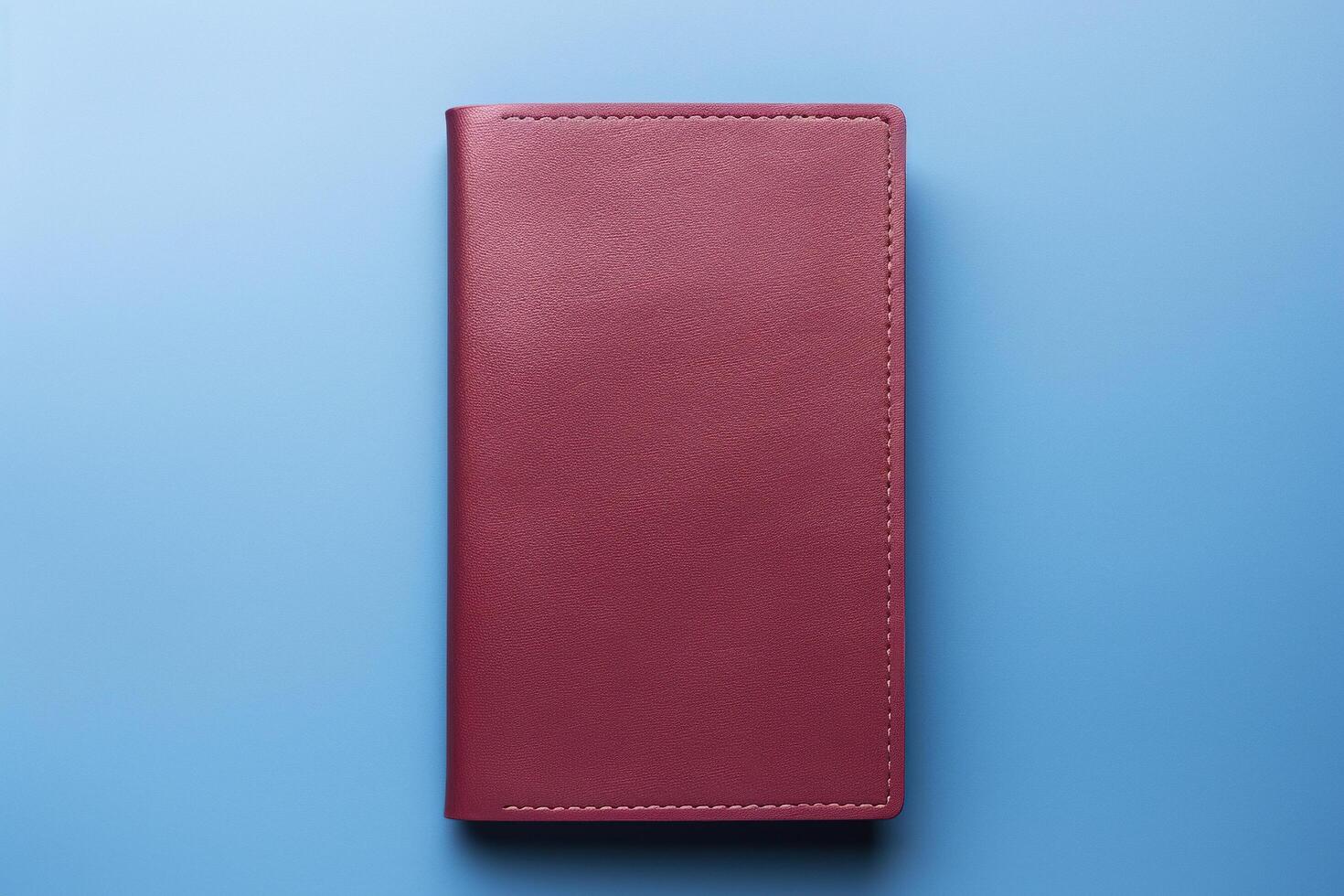 AI generated Notebook in a red leather cover on a blue background. Generated by artificial intelligence photo