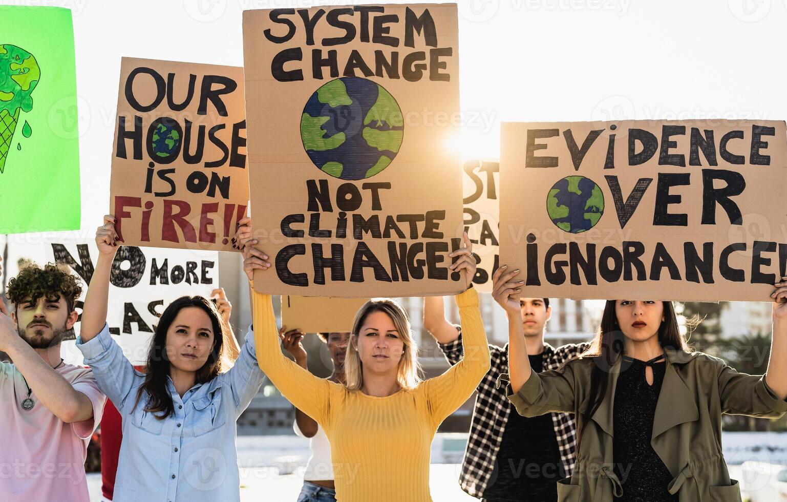 Group of young and diverse activists protesting for climate change - Global warming concept photo