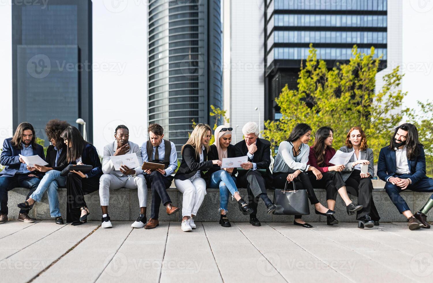 Panoramic view of business people having a briefing outside the office photo