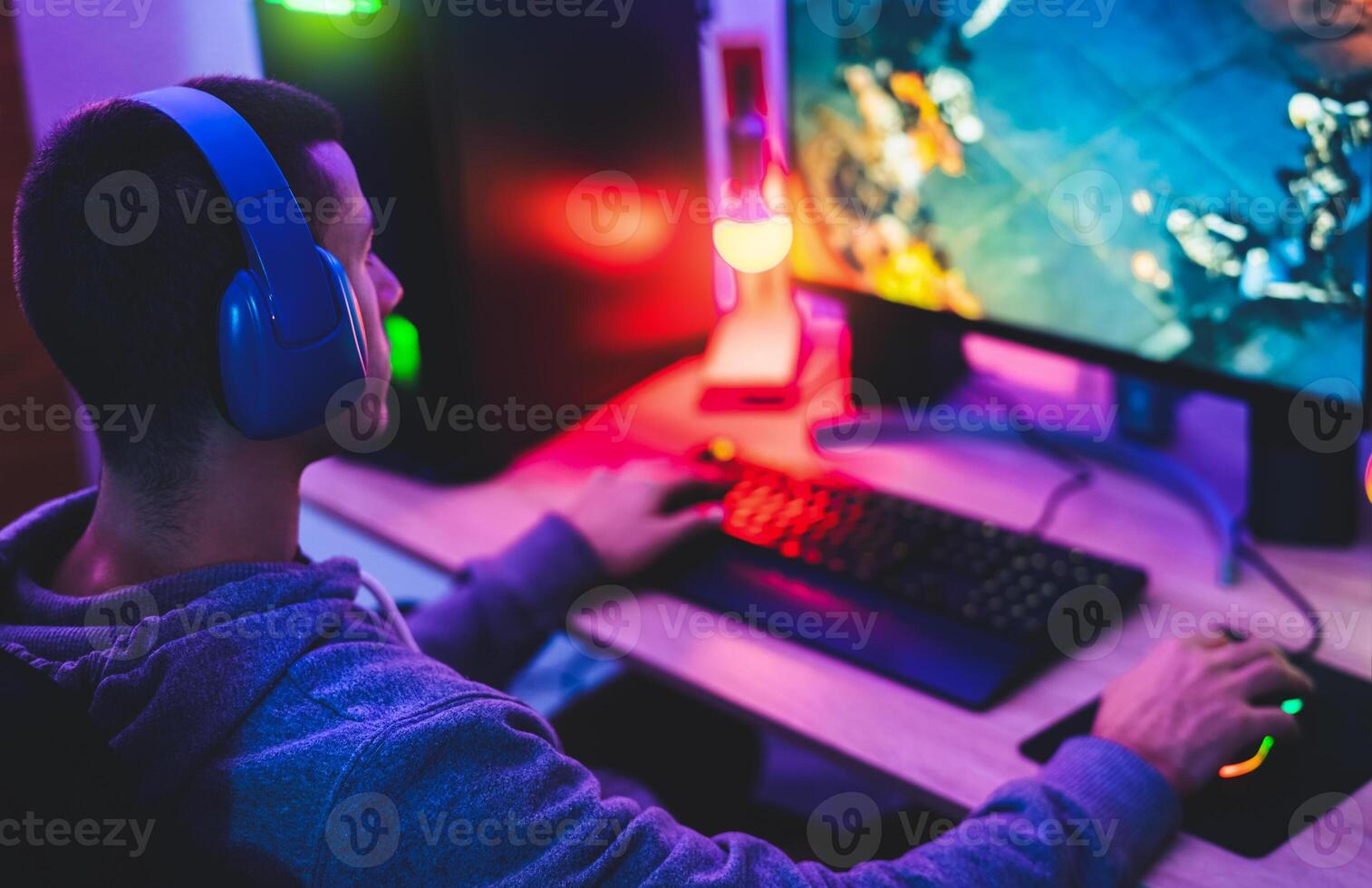 Young gamer playing online video games while streaming on social media - Youth people addicted to new technology game photo