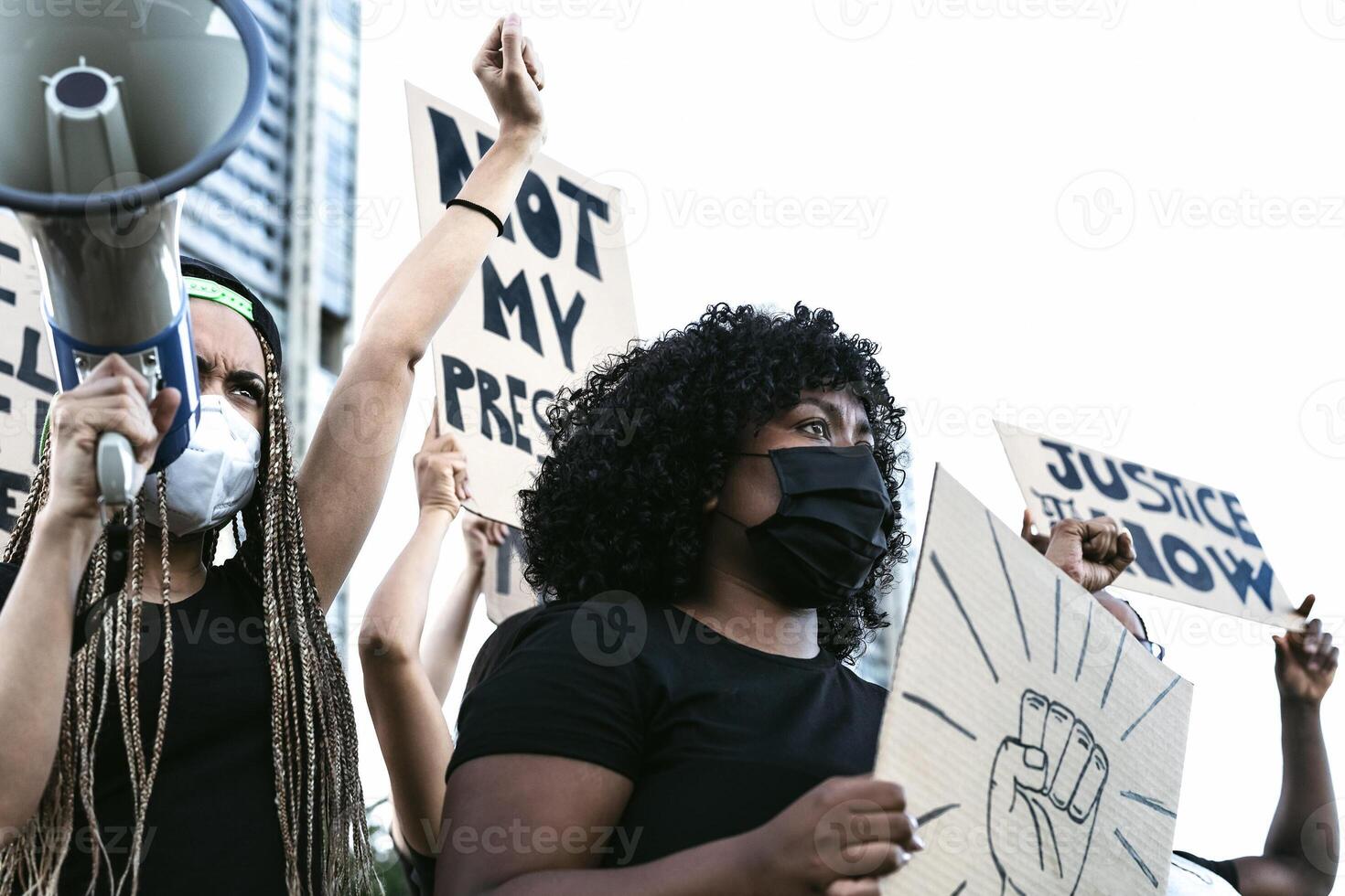 Activist movement protesting against racism and fighting for equality - Demonstrators from different cultures and race protest on street for equal rights - Black lives matter protests city concept photo