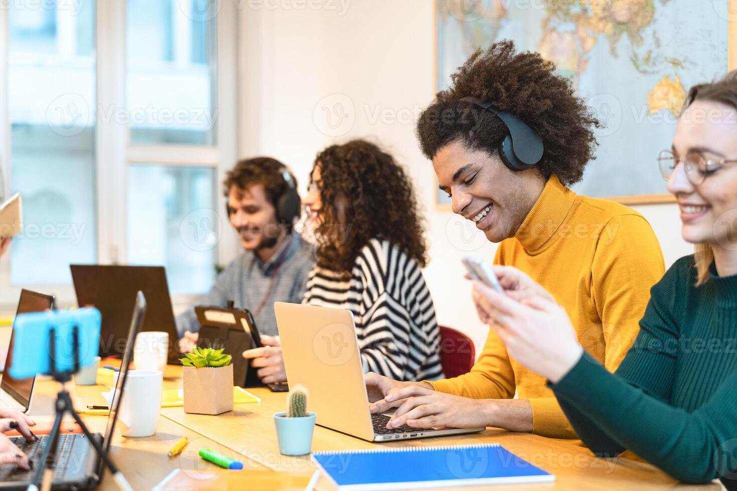 Young friends working together inside co-working creative space - Teamwork doing startup strategy in modern office - Youth millennial generation and technology concept photo