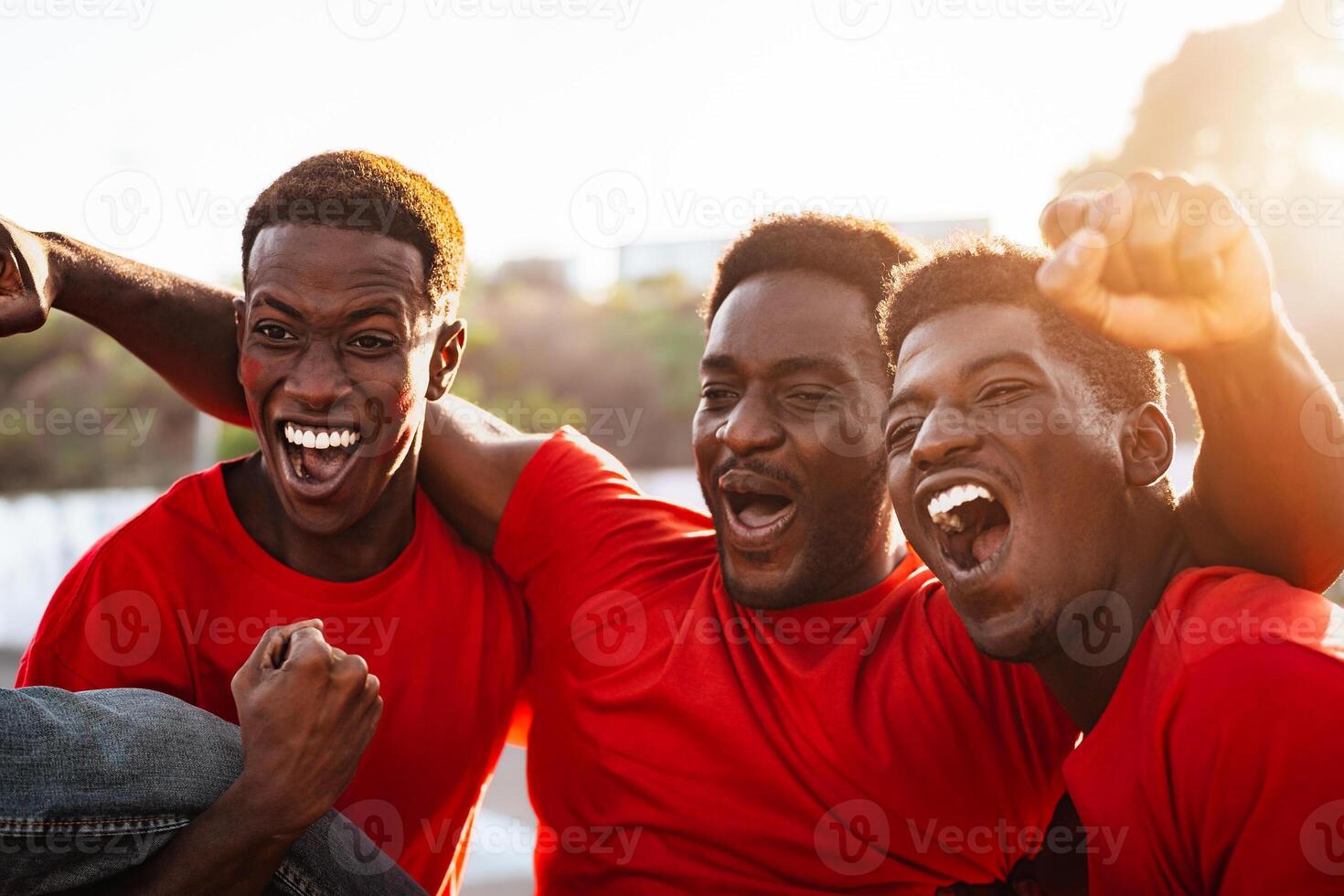 African football fans having fun supporting their favorite team - Sport entertainment concept photo