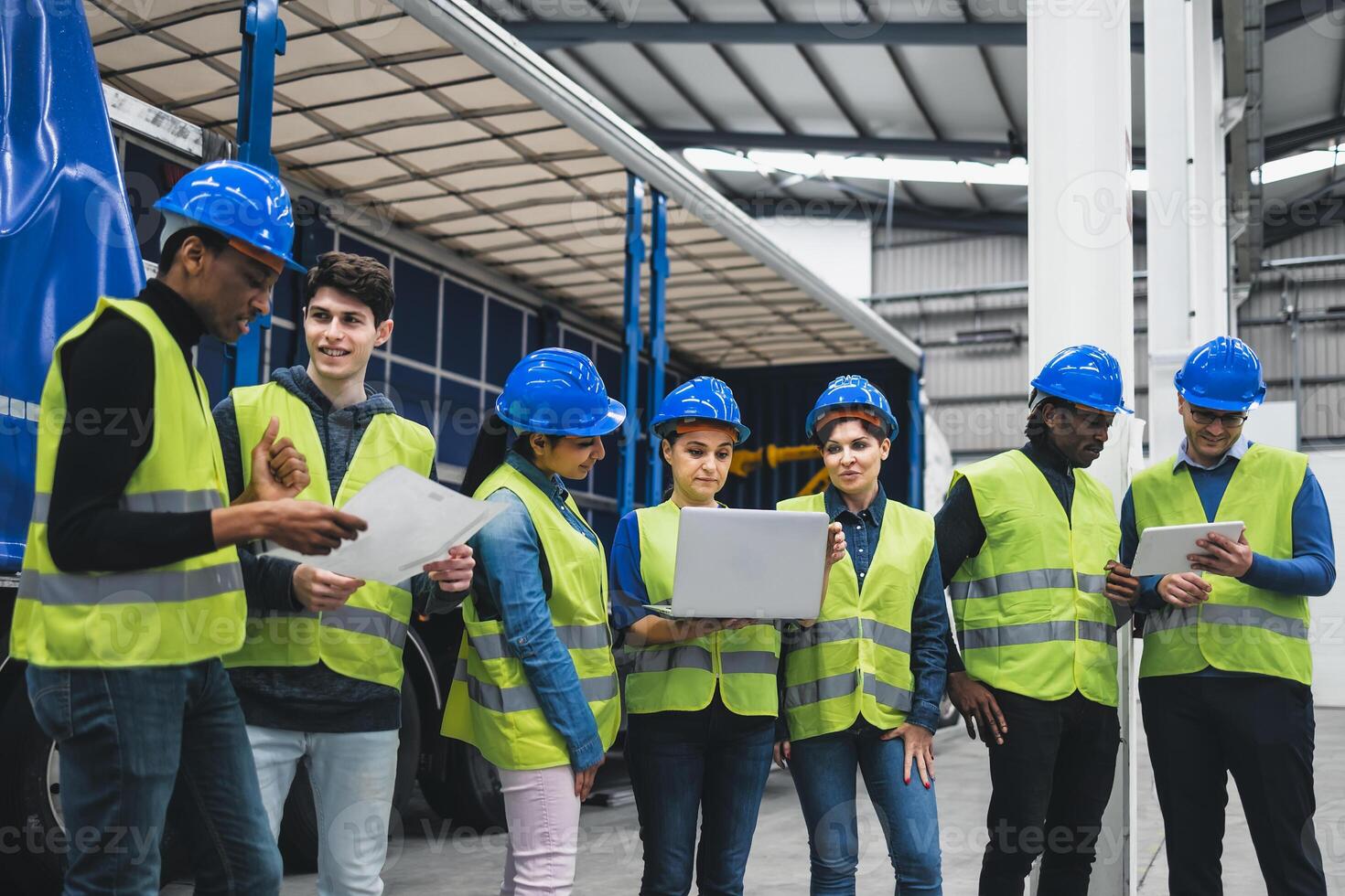 Team of multiracial engineers working in robotic factory - Tech industrial concept photo