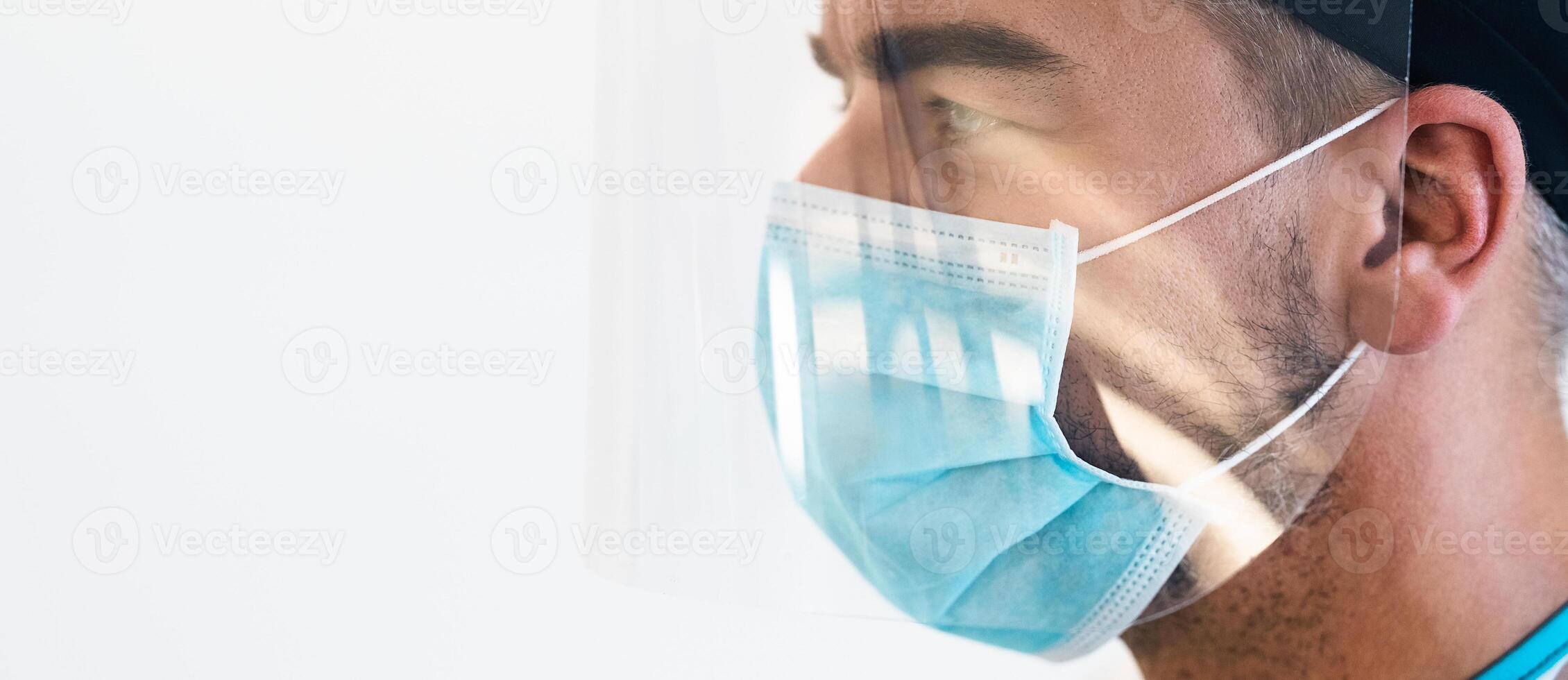 Doctor wearing ppe face surgical mask and visor fighting against corona virus outbreak - Health care and medical workers concept photo