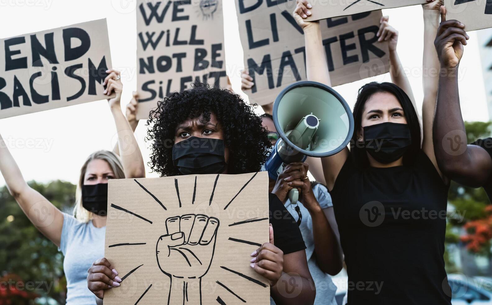 Activist movement protesting against racism and fighting for equality - Demonstrators from different cultures and race protest on street for equal rights - Black lives matter protests city concept photo