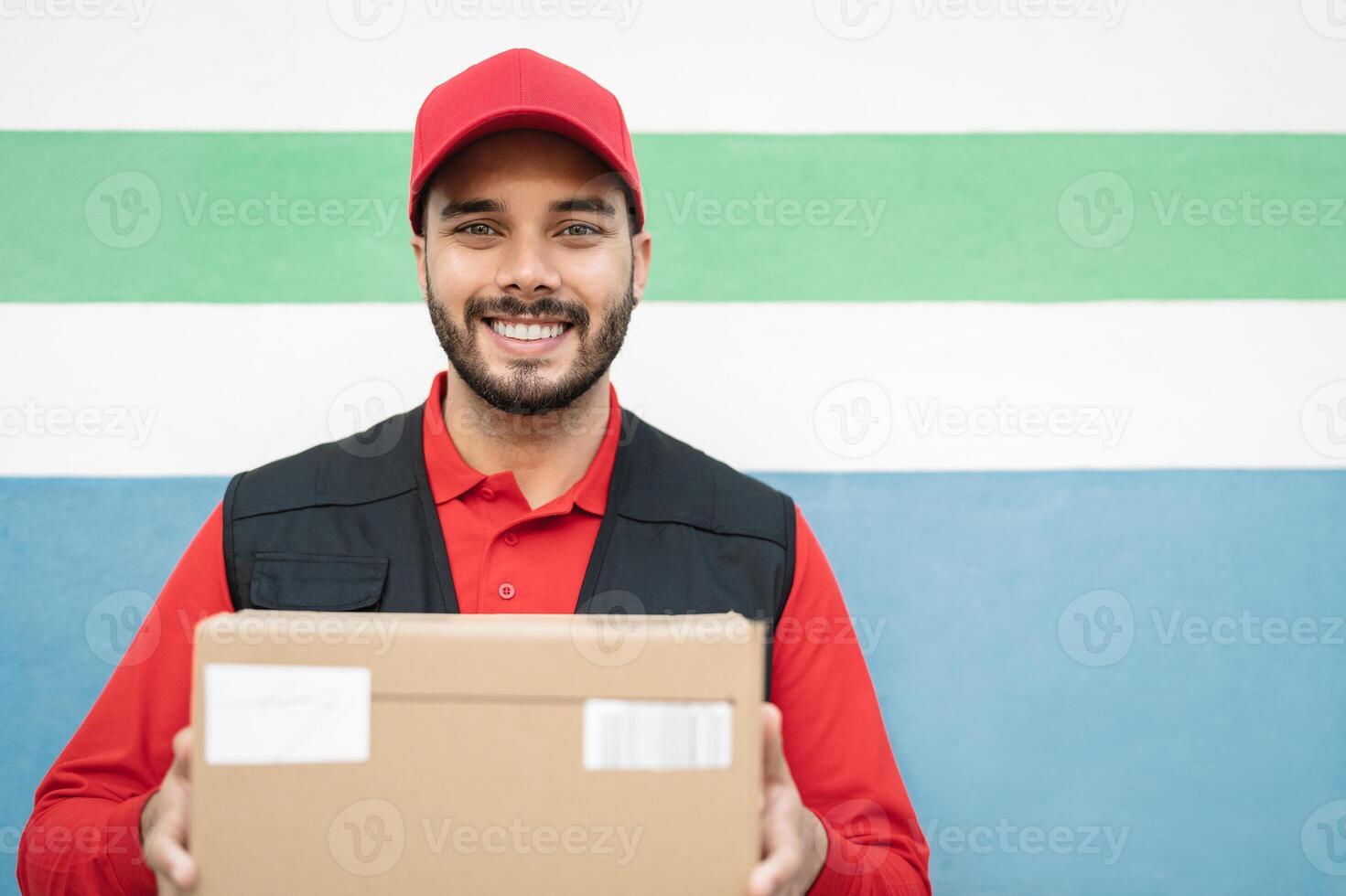 Young delivery man carrying cardboard box - People working with fast deliver transportation photo