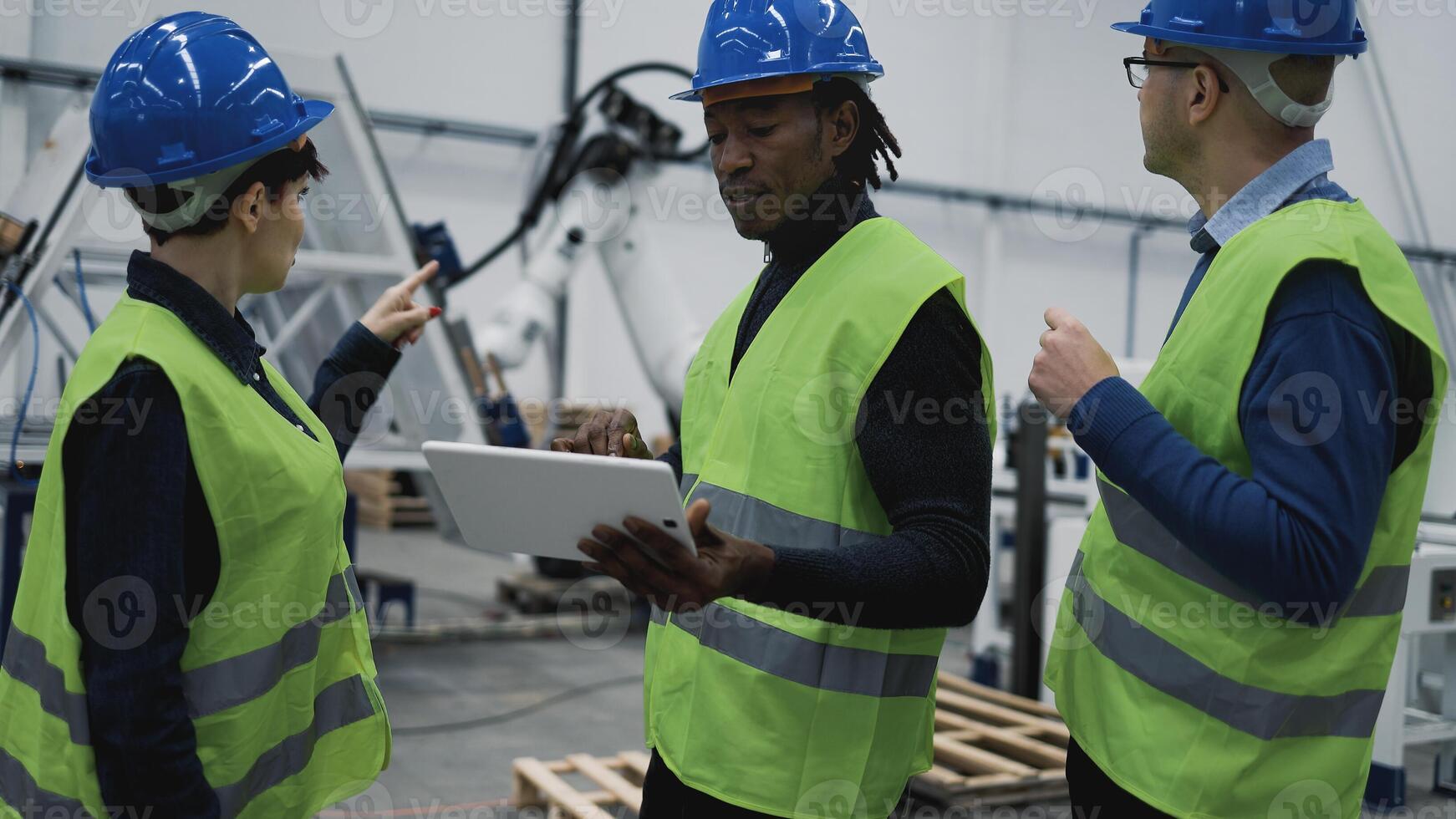 Team of engineers working in robotic factory monitoring the project on the tablet - Tech industry concept photo