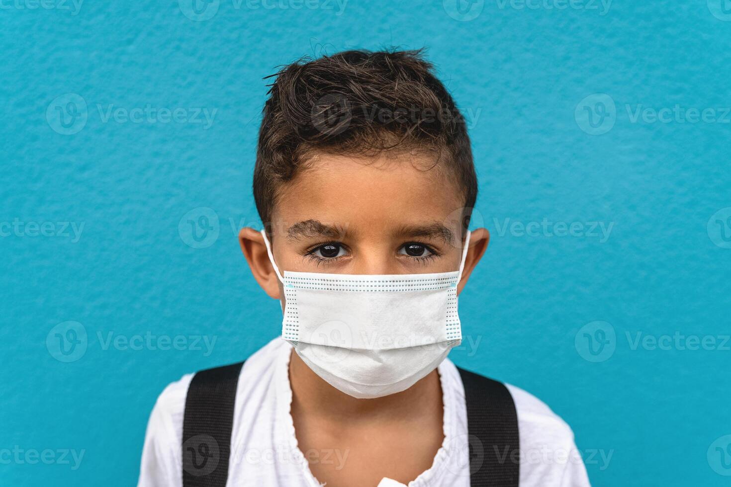 Child wearing face protective mask going back to school during corona virus pandemic photo