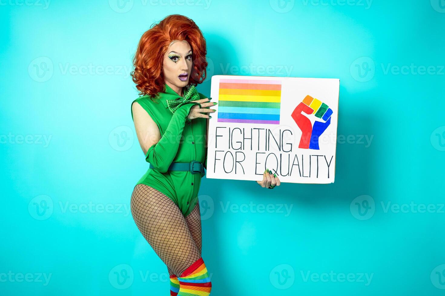 Happy drag queen celebrating gay pride holding banner with rainbow flag - LGBTQ social movement concept photo